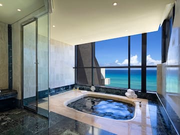 a bathroom with a hot tub and a large window
