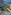 Sunny resort, multiple pools, sandy beach, blue ocean, and coastal hotels.