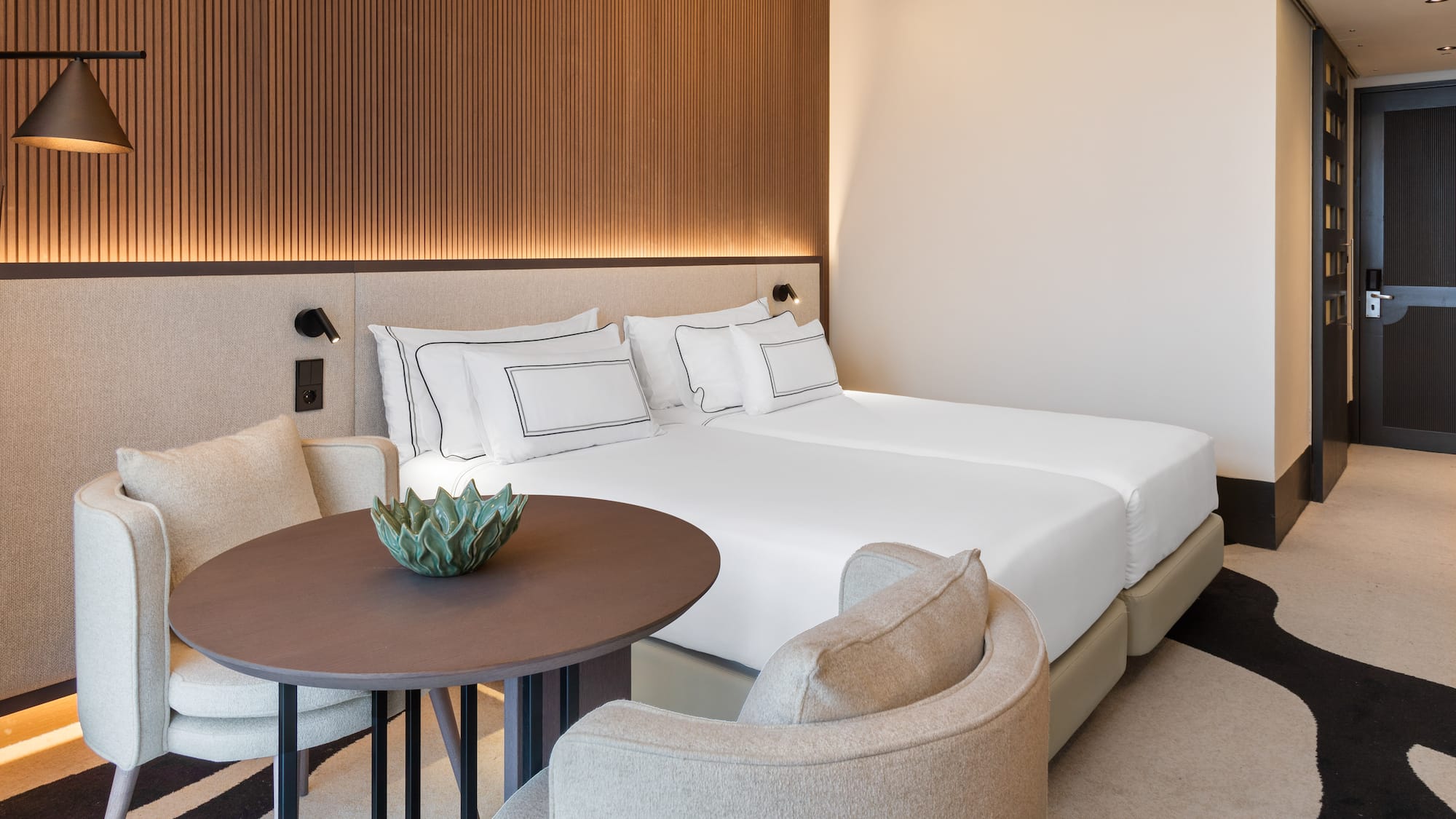 a room with a bed and chairs