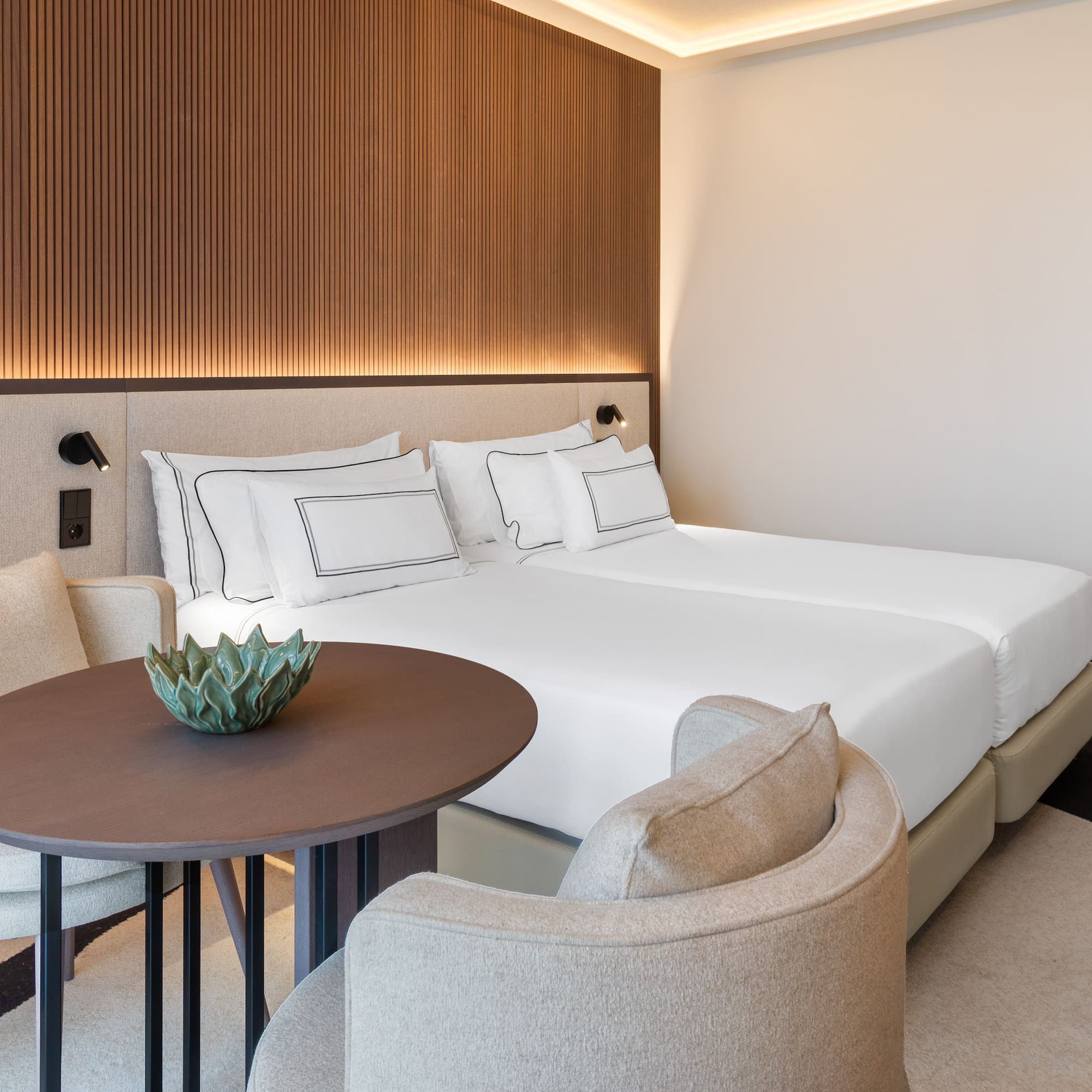 a room with a bed and chairs