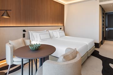 a room with a bed and chairs