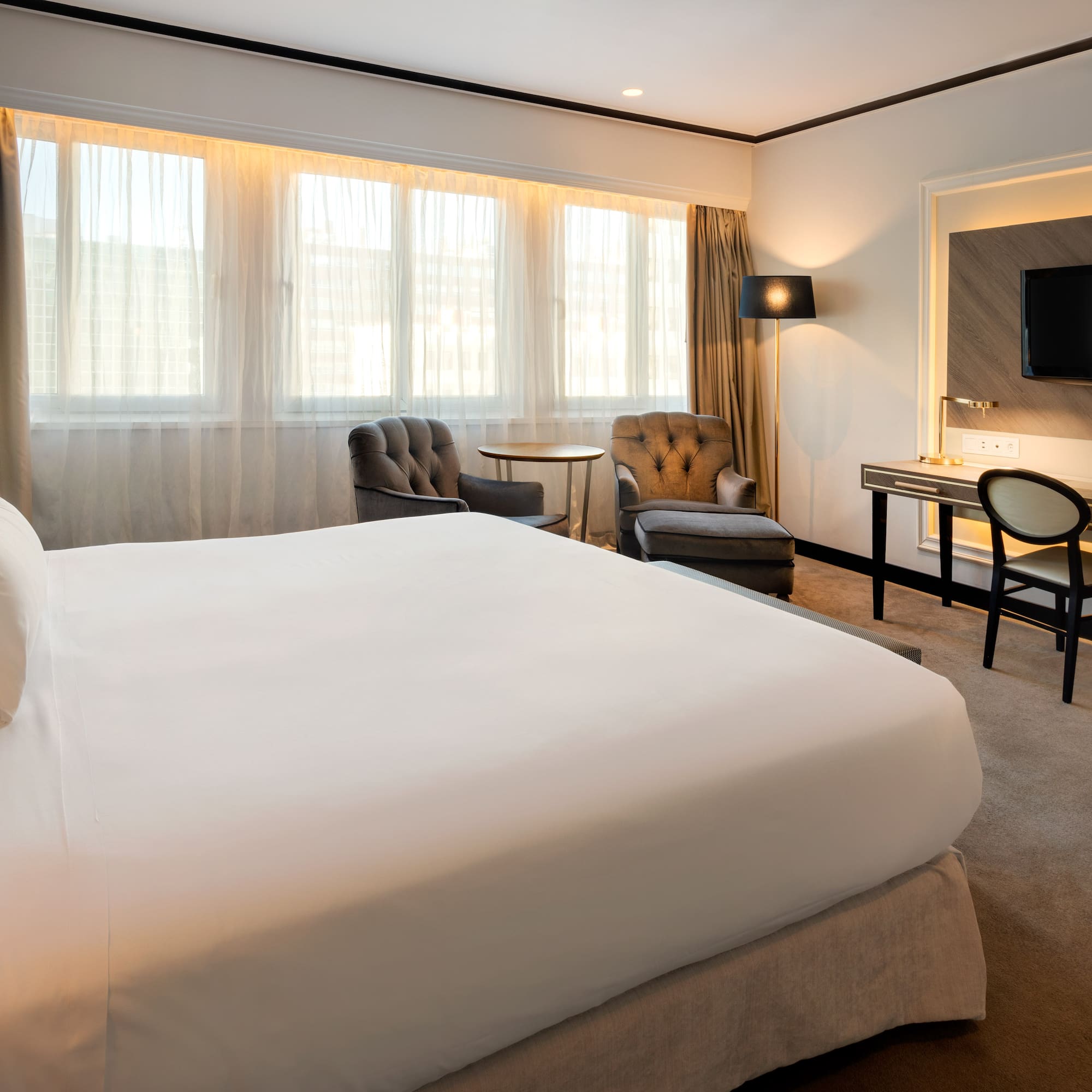 a hotel room with a bed and a desk