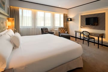 a hotel room with a bed and a desk