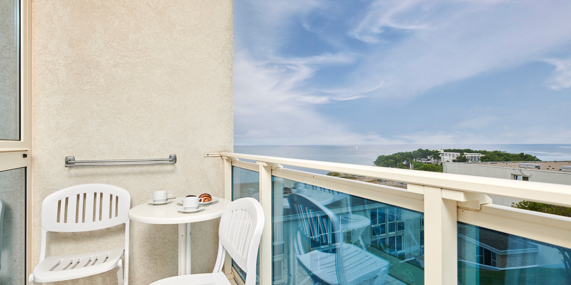a table and chairs on a balcony