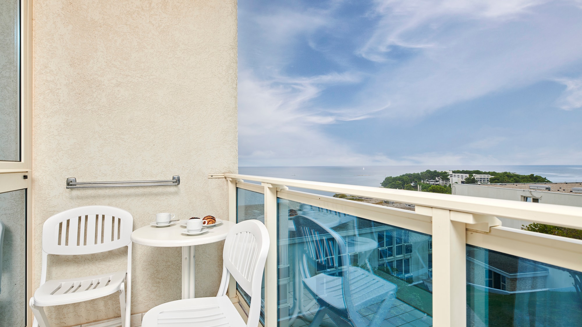 a table and chairs on a balcony