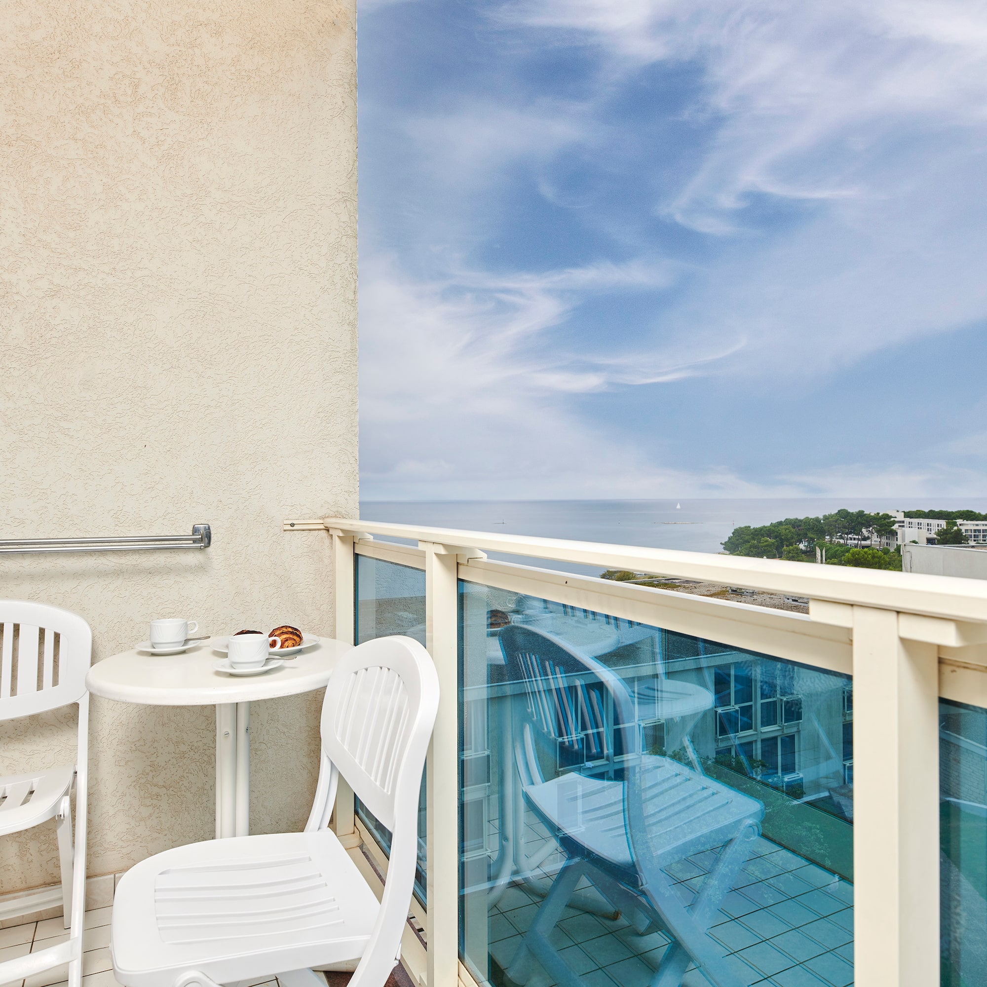 a table and chairs on a balcony