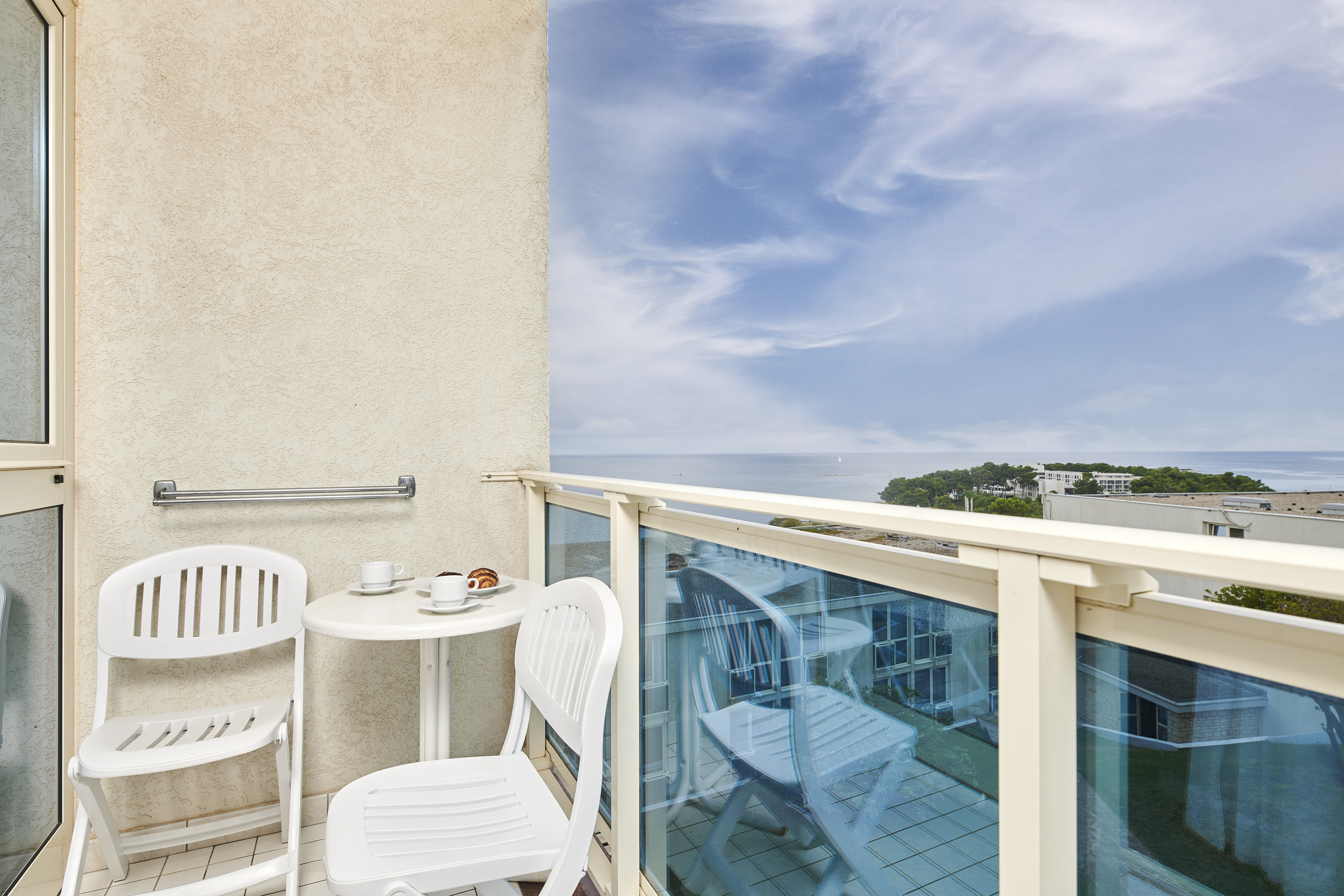 a table and chairs on a balcony