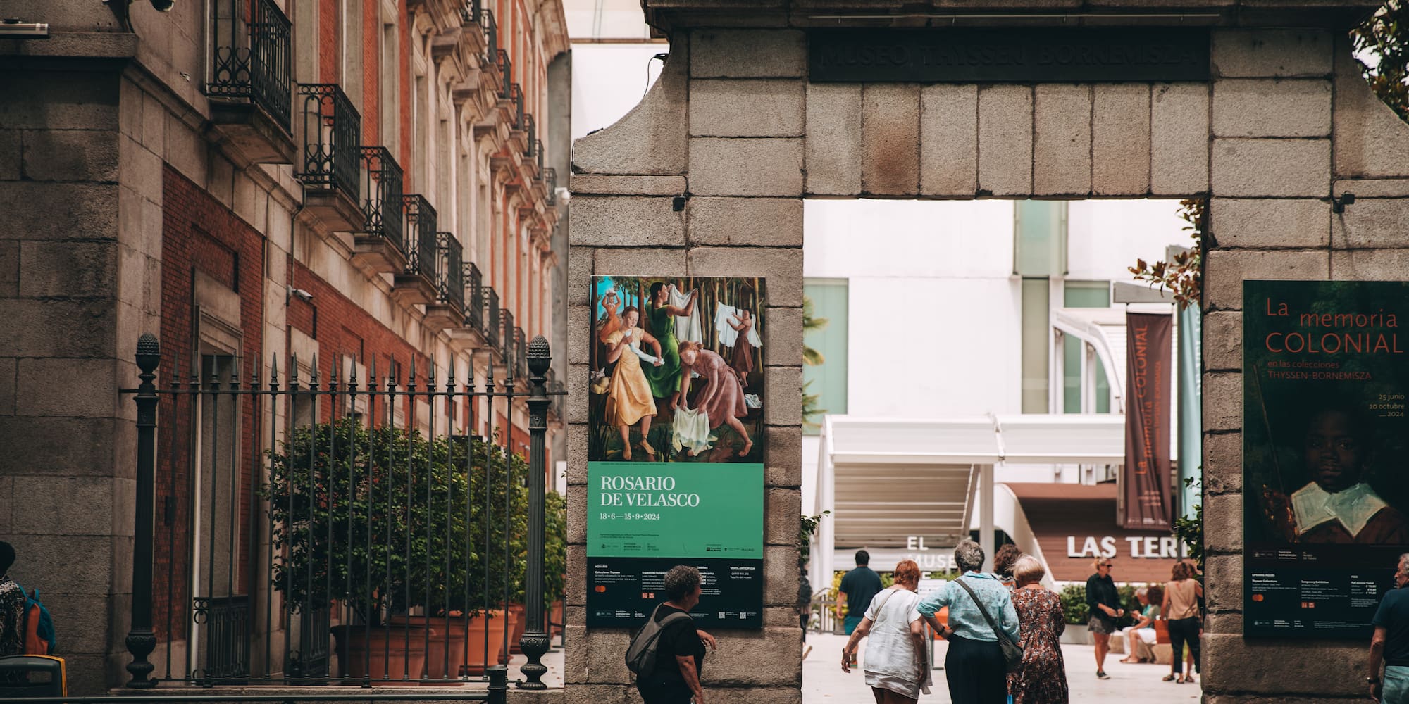 a group of people standing next to a stone arch