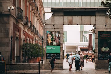 a group of people standing next to a stone arch