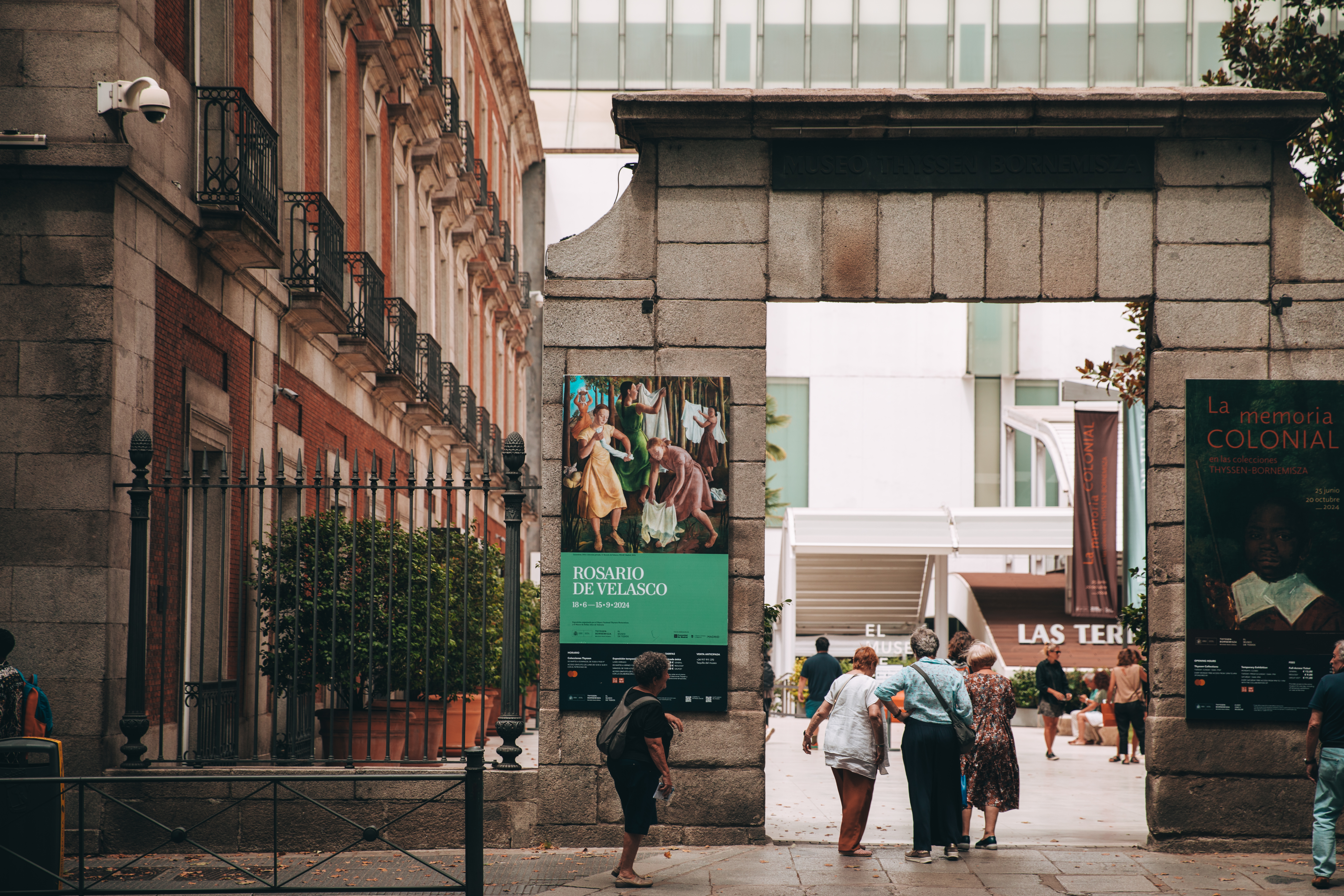 a group of people standing next to a stone arch