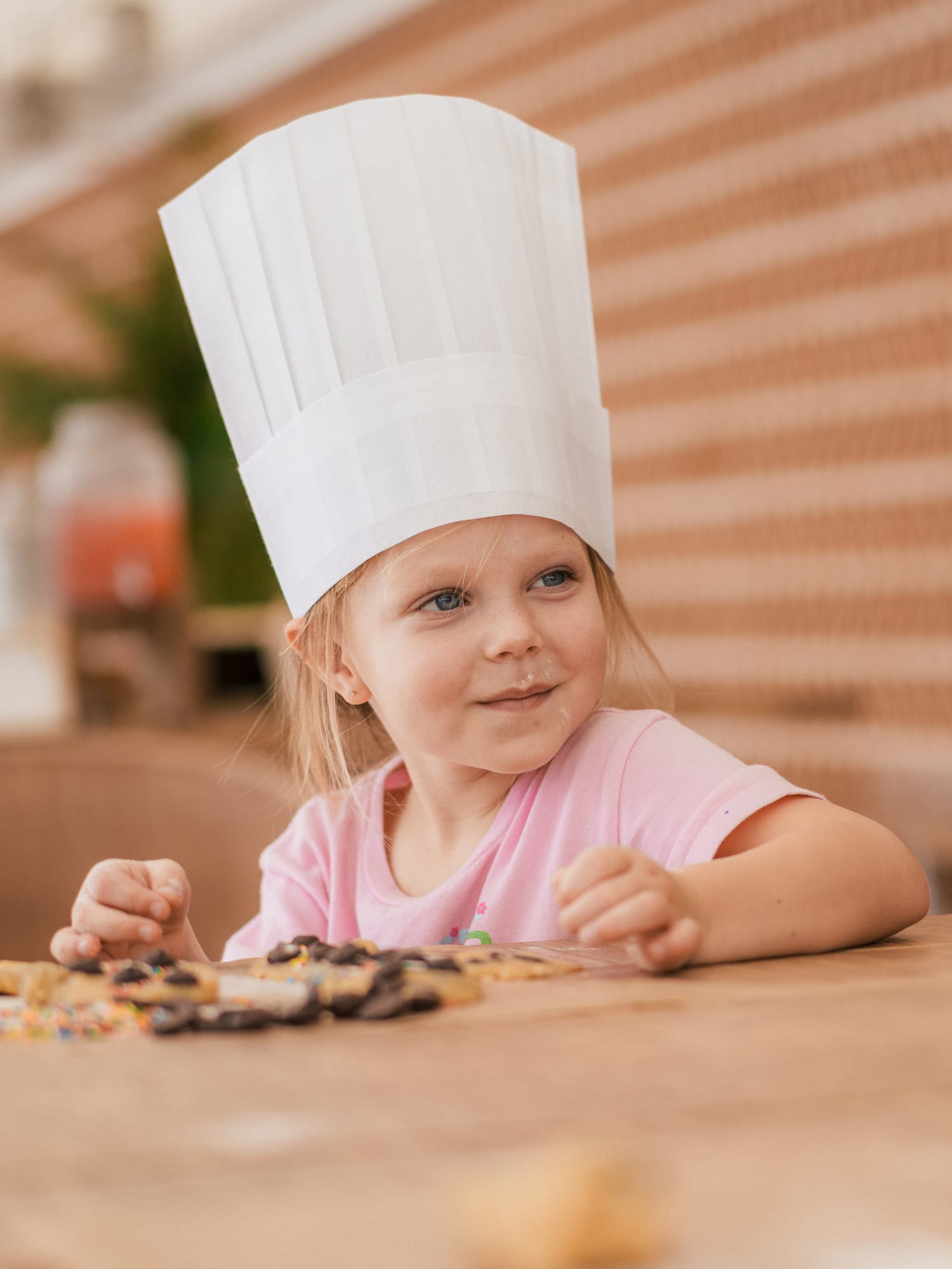 a girl wearing a chef hat