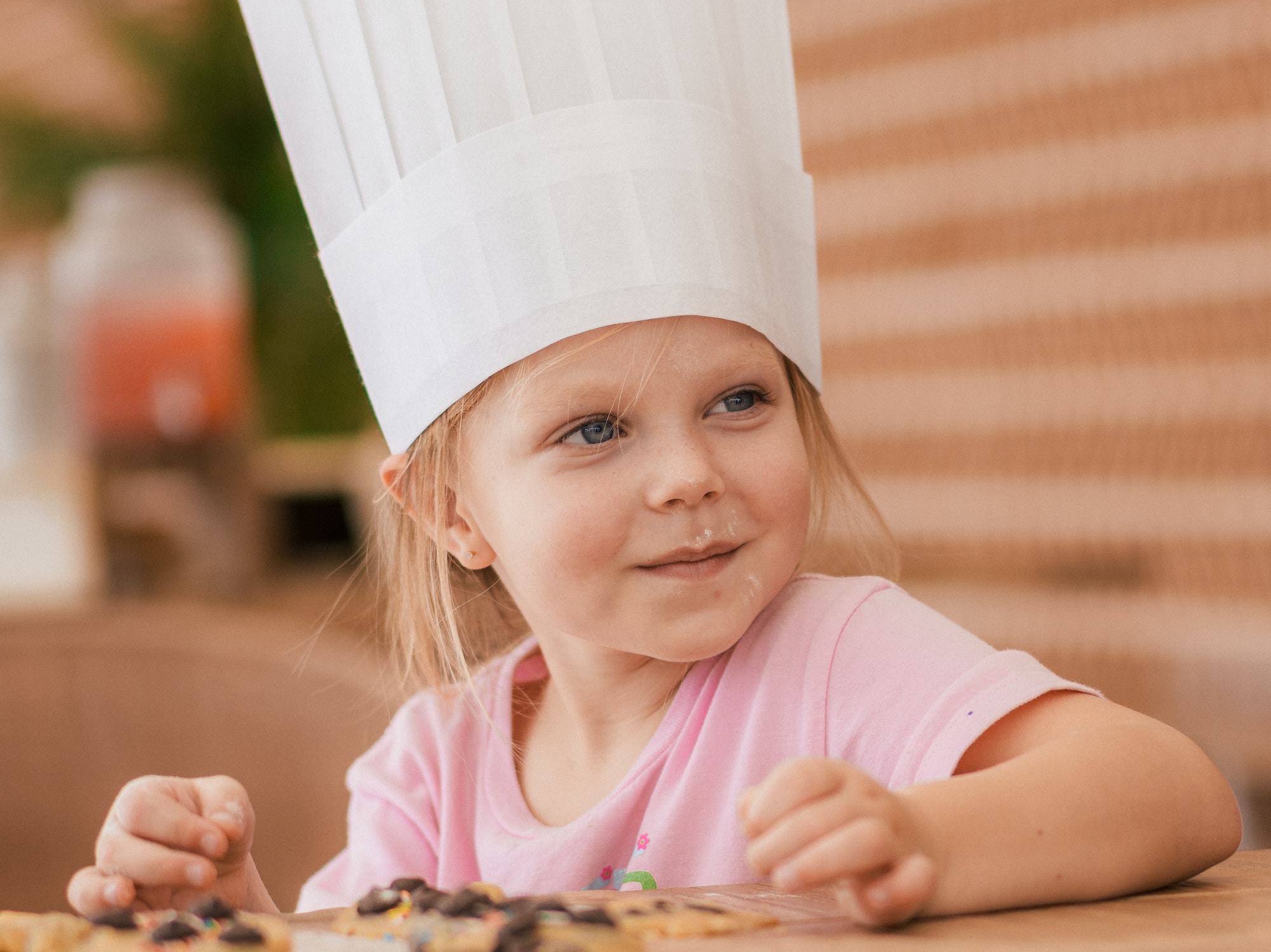 a girl wearing a chef hat