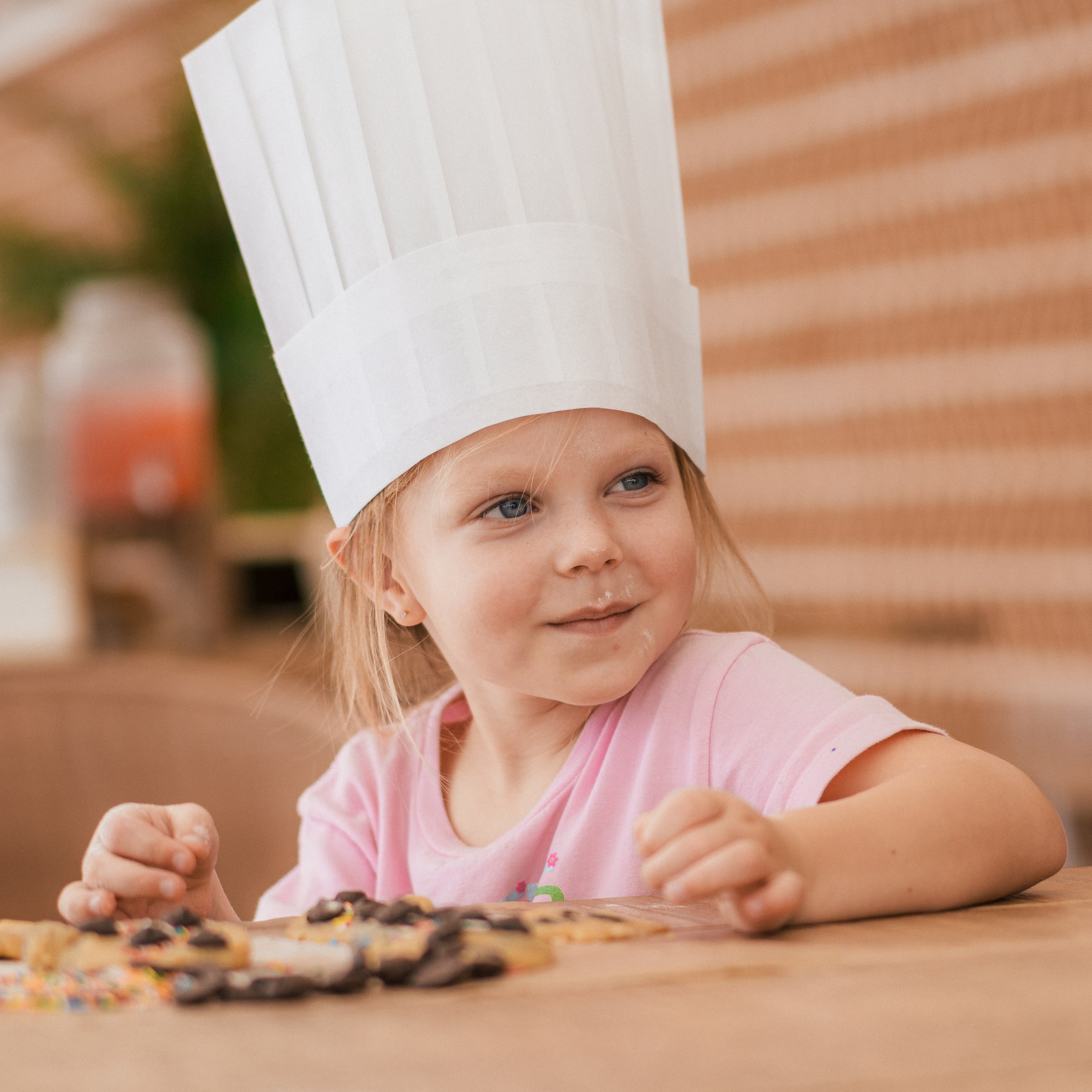 a girl wearing a chef hat