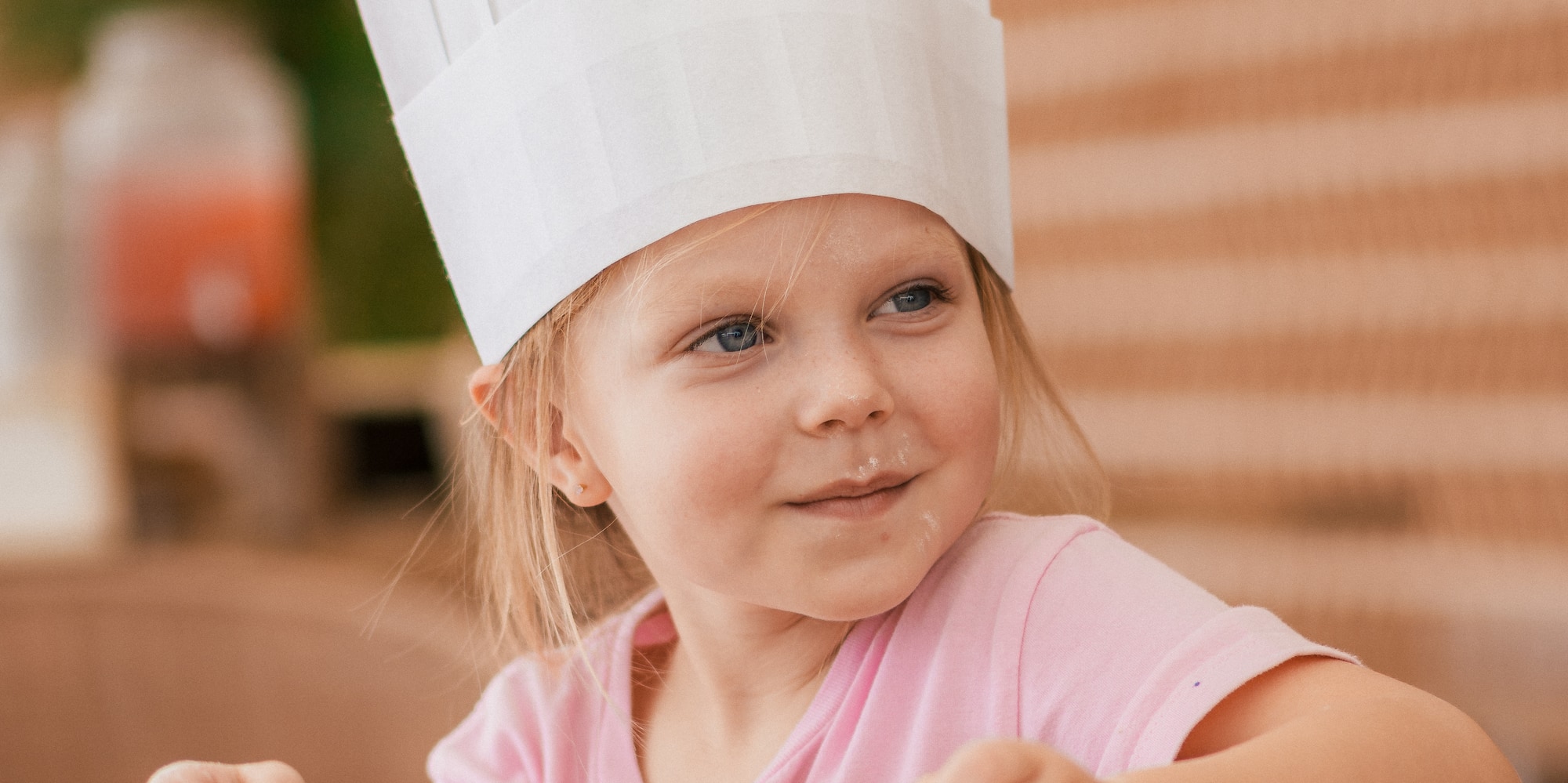 a girl wearing a chef hat
