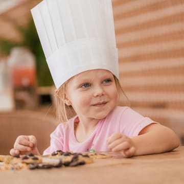 a girl wearing a chef hat
