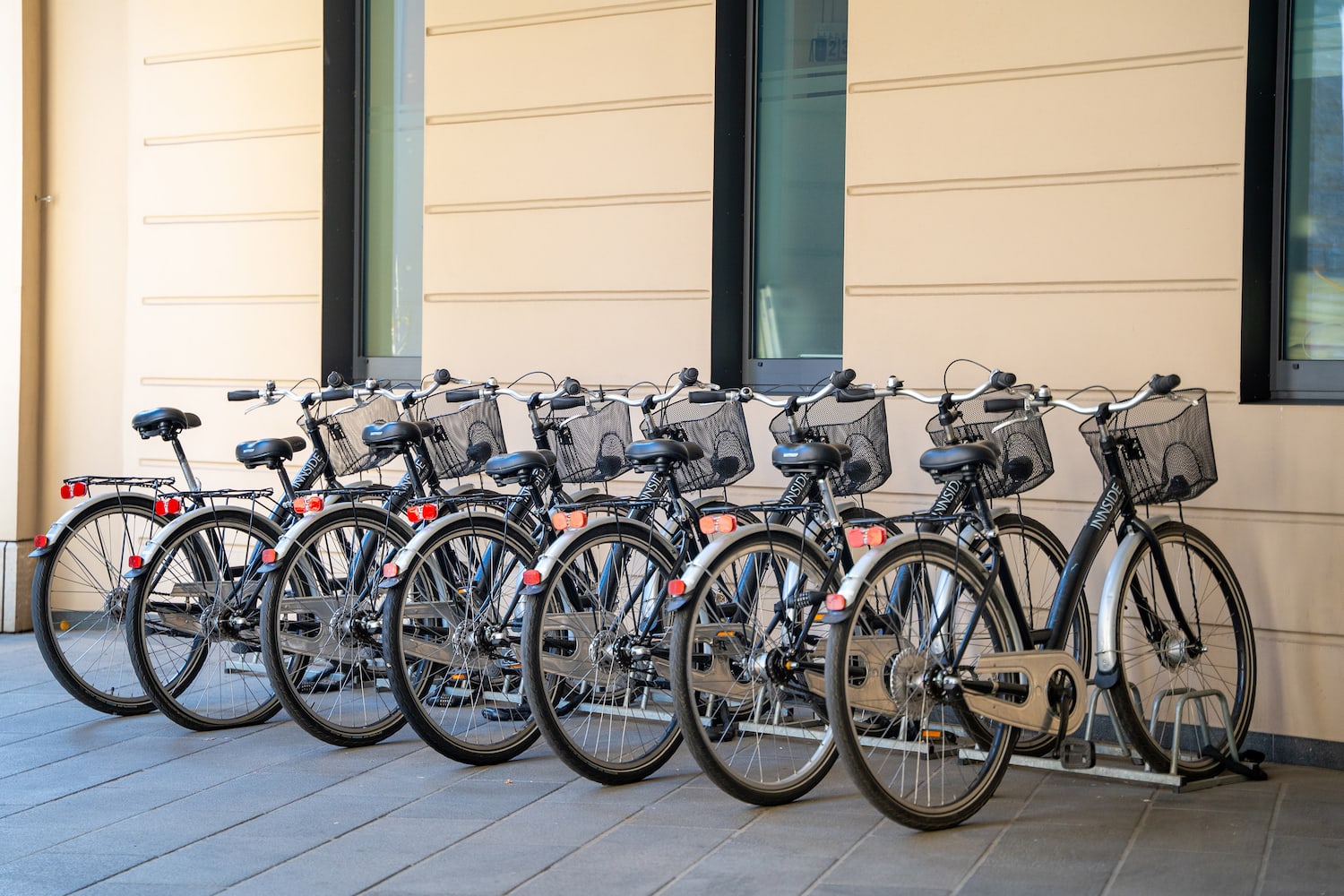a row of bicycles parked in front of a building