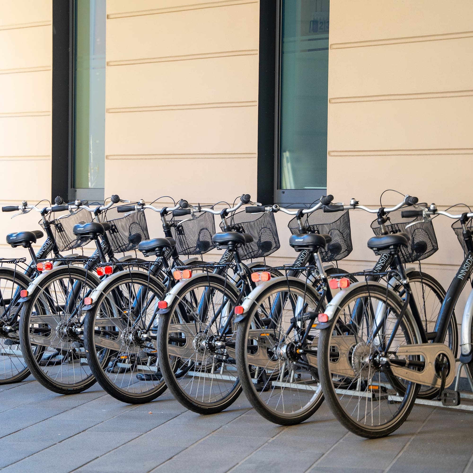 a row of bicycles parked in front of a building