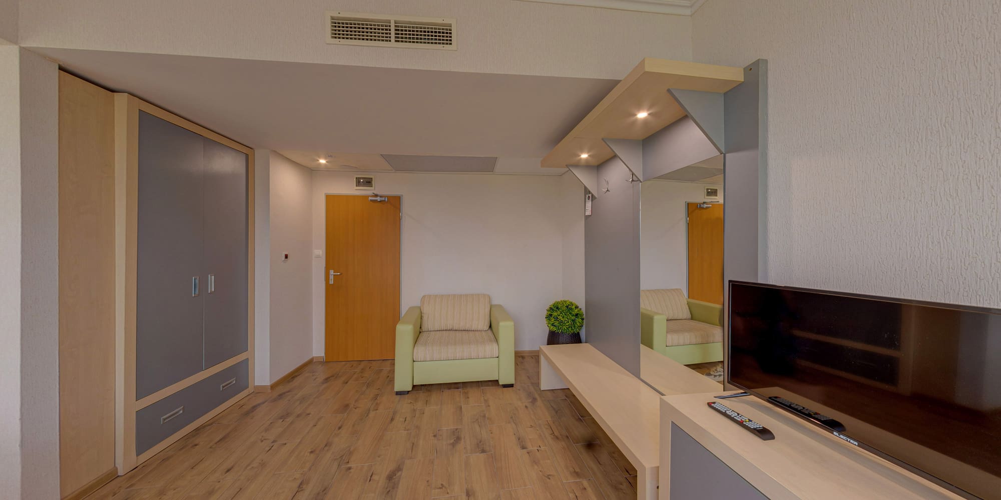 a room with a television and a wood floor