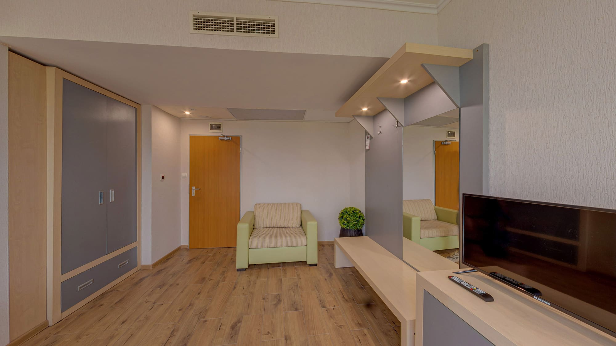 a room with a television and a wood floor