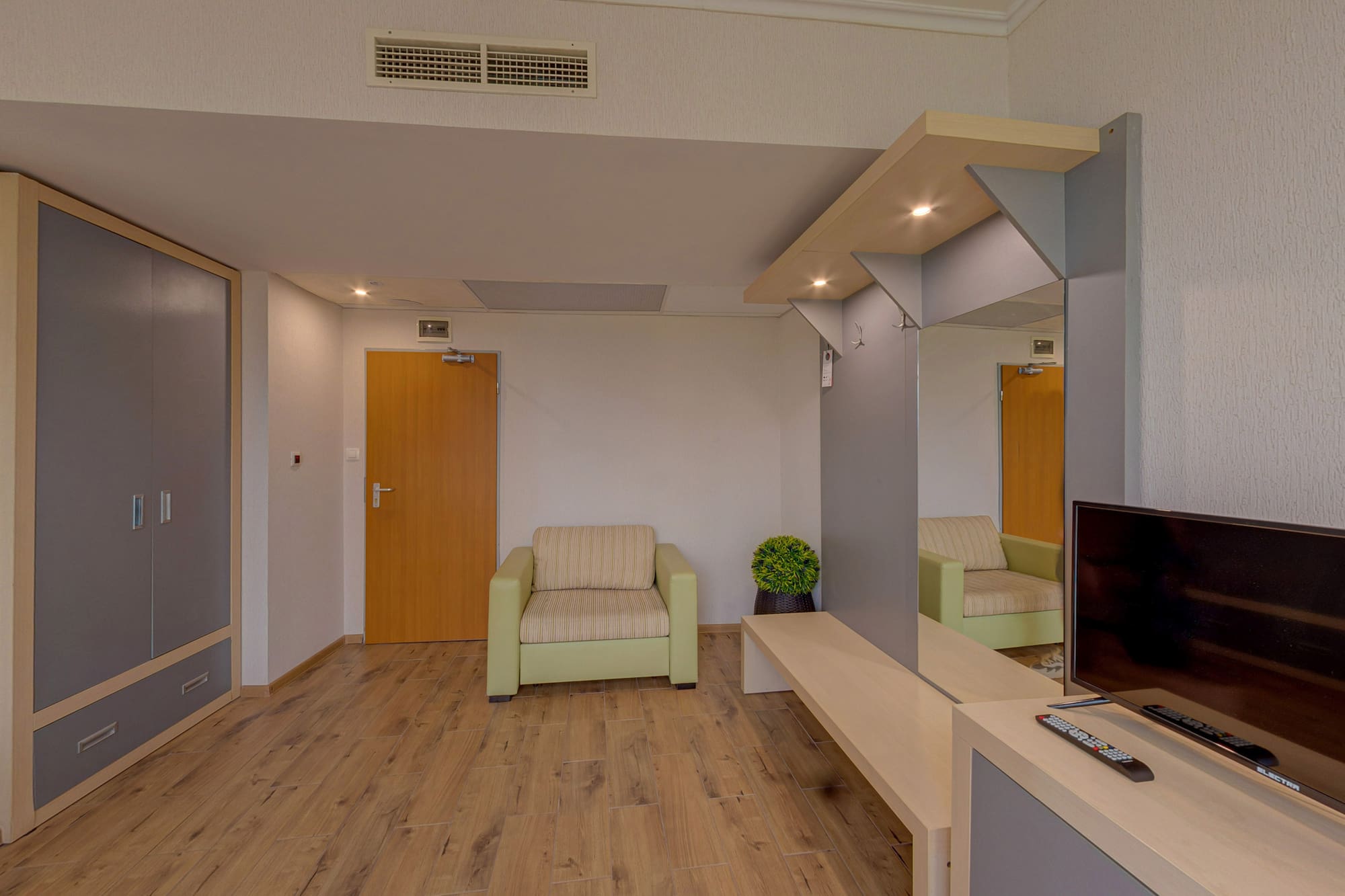 a room with a television and a wood floor