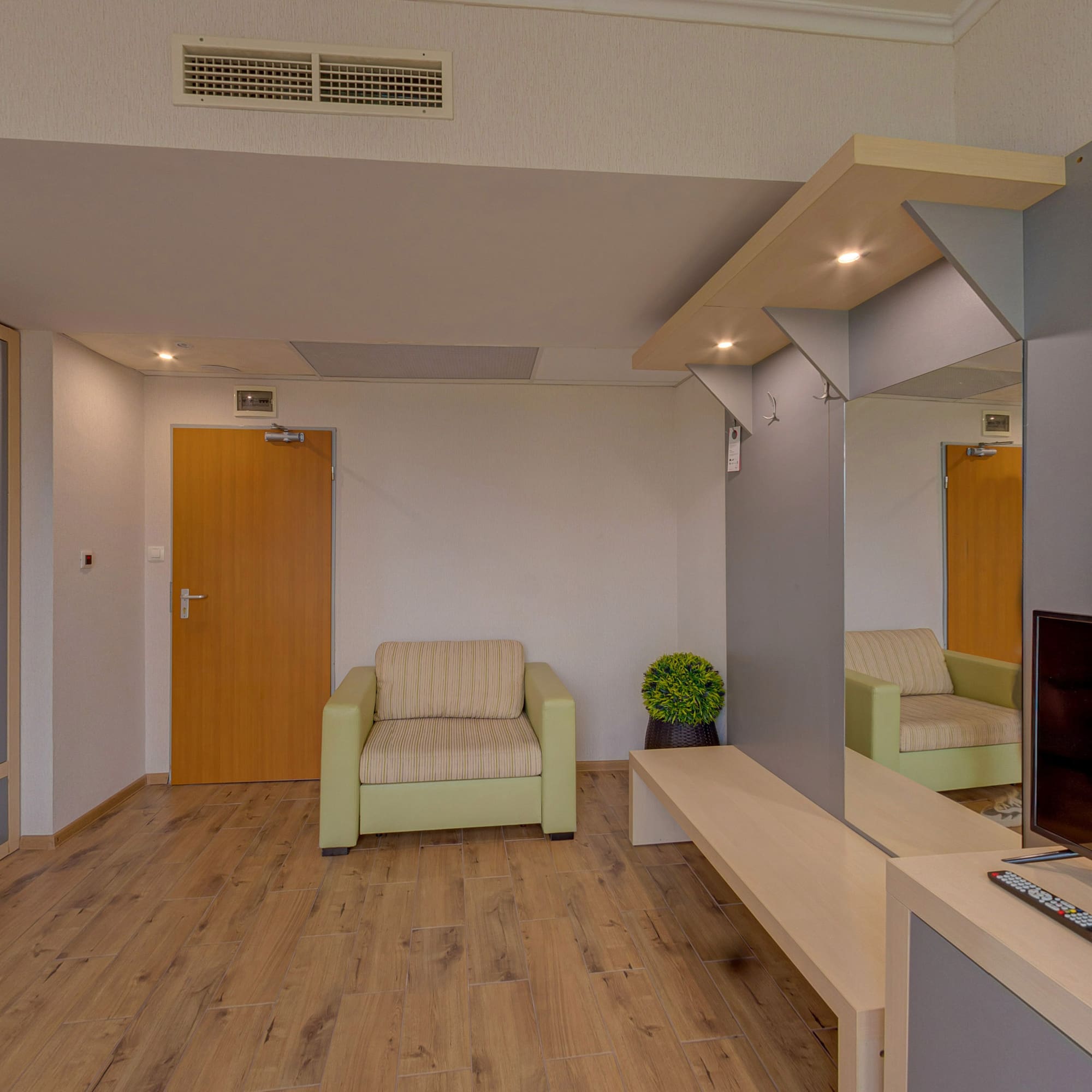 a room with a television and a wood floor