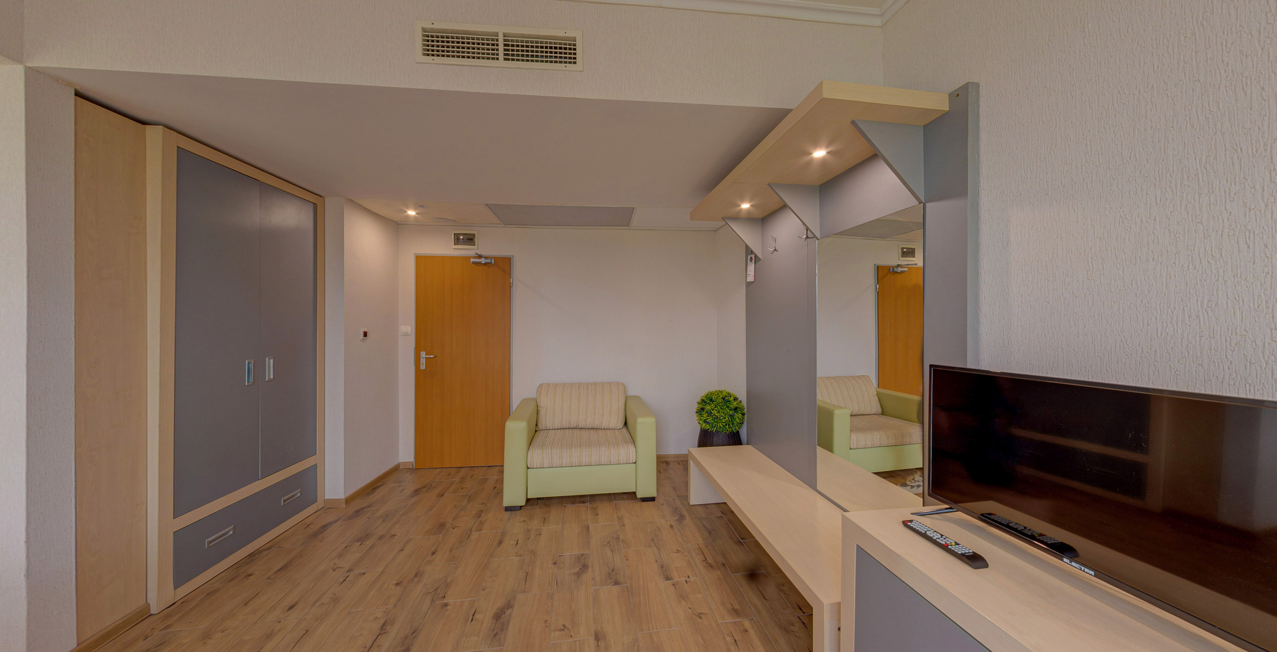 a room with a television and a wood floor
