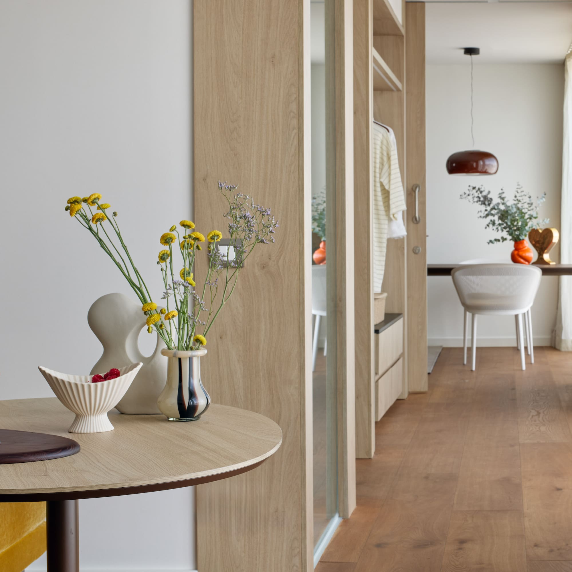 a table with vases of flowers and a table with a dining table