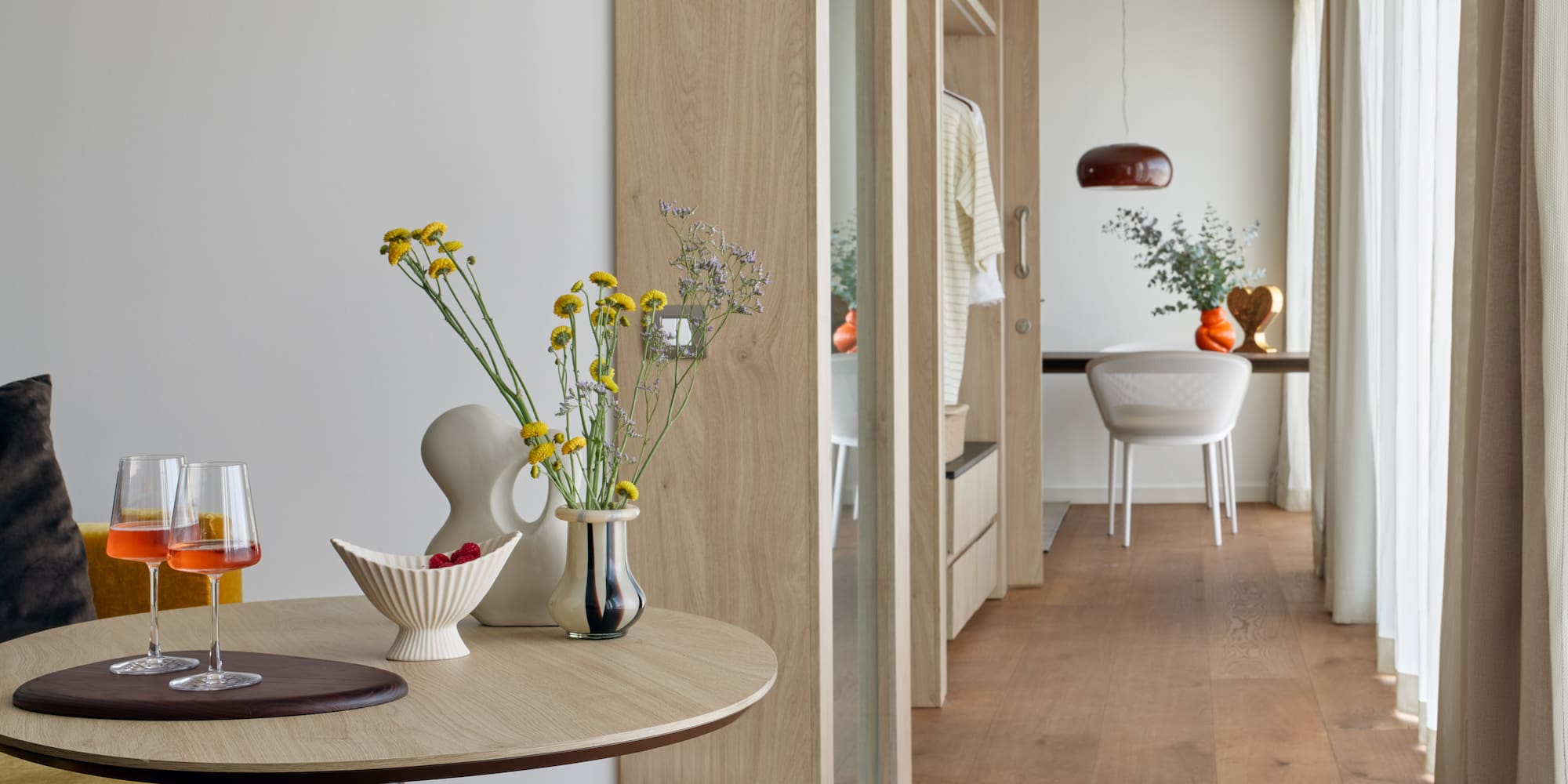 a table with vases of flowers and a table with a dining table