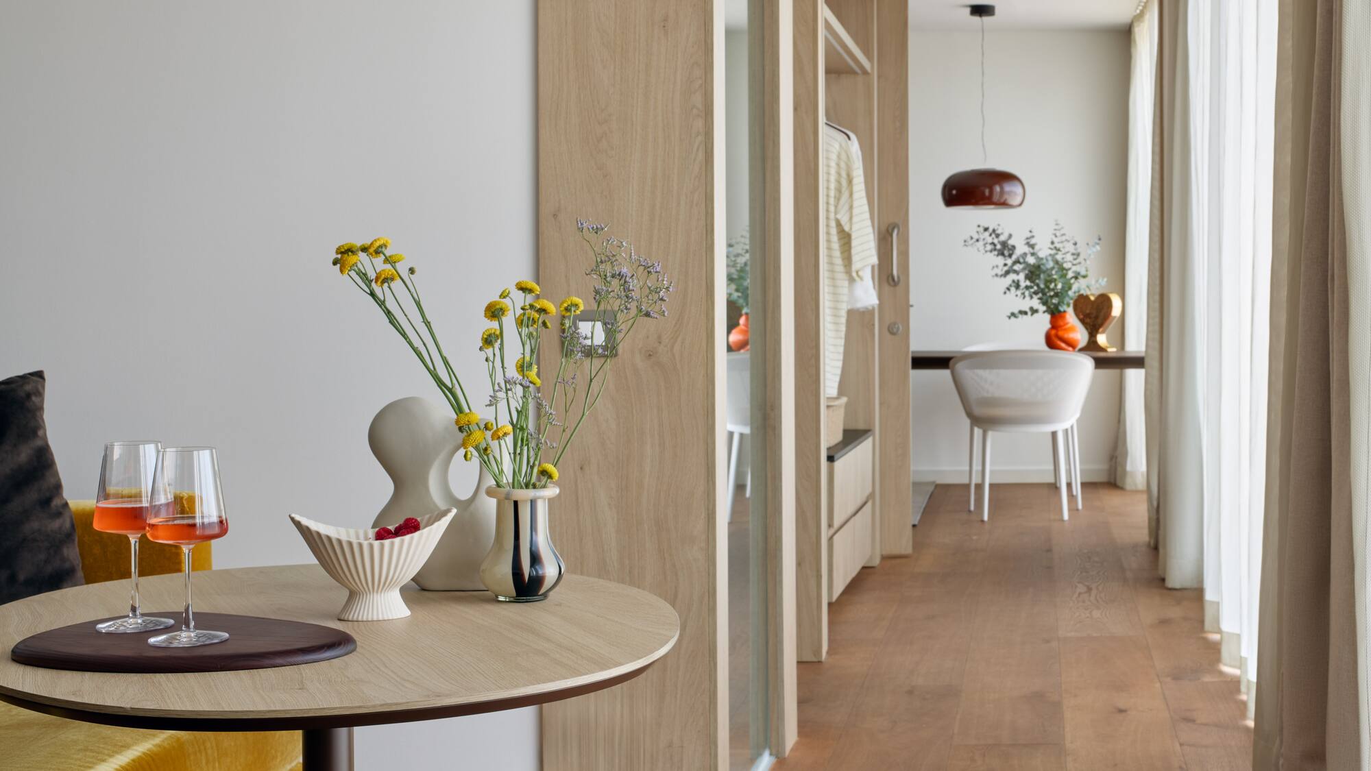 a table with vases of flowers and a table with a dining table