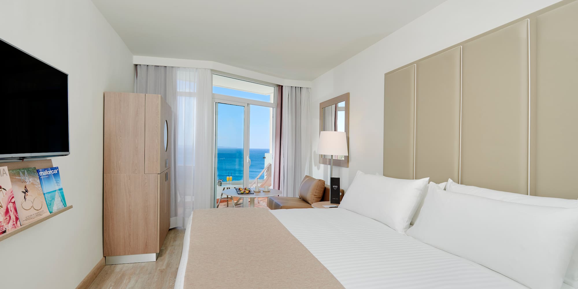 a room with a bed and a table and chairs