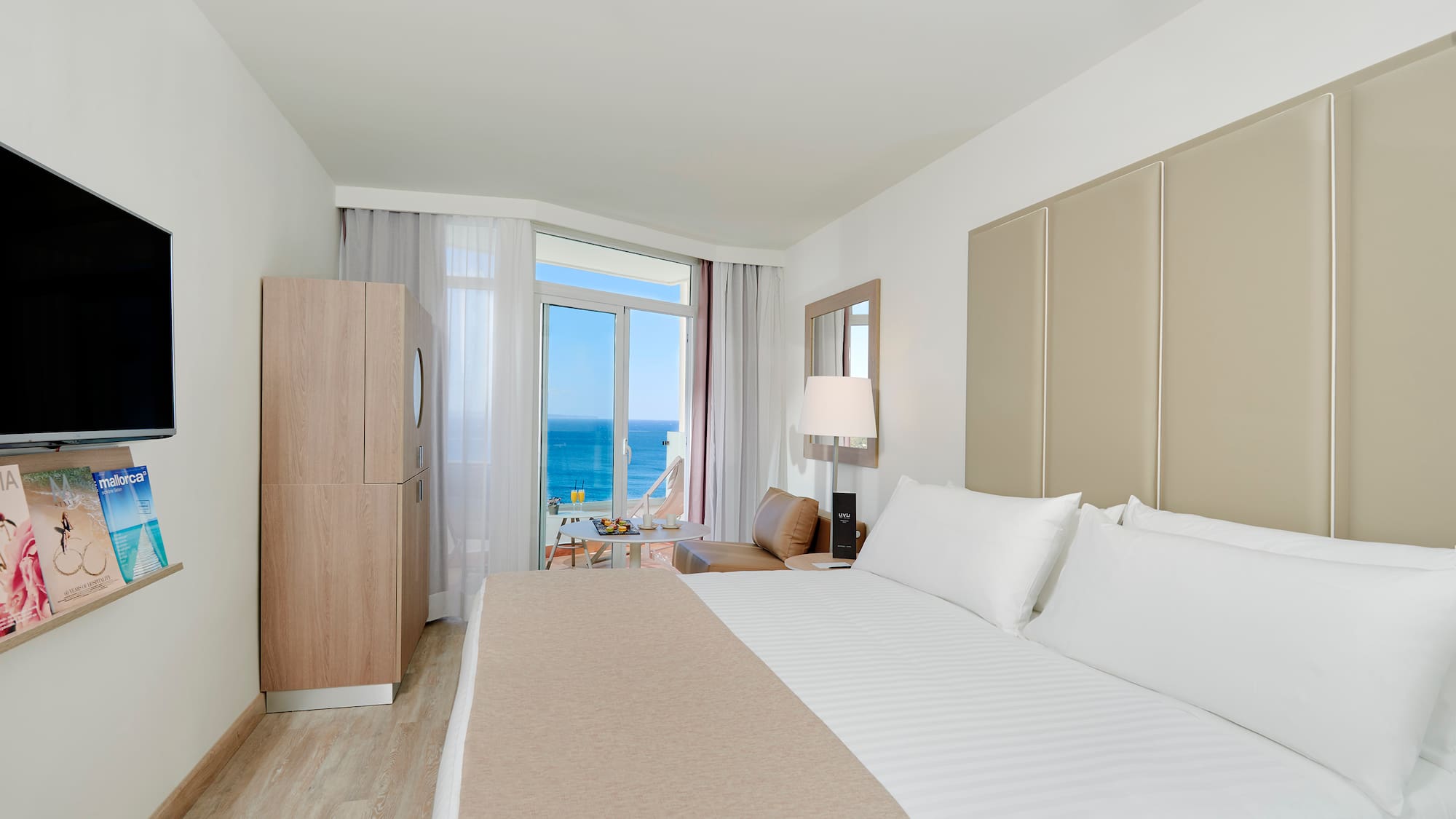 a room with a bed and a table and chairs