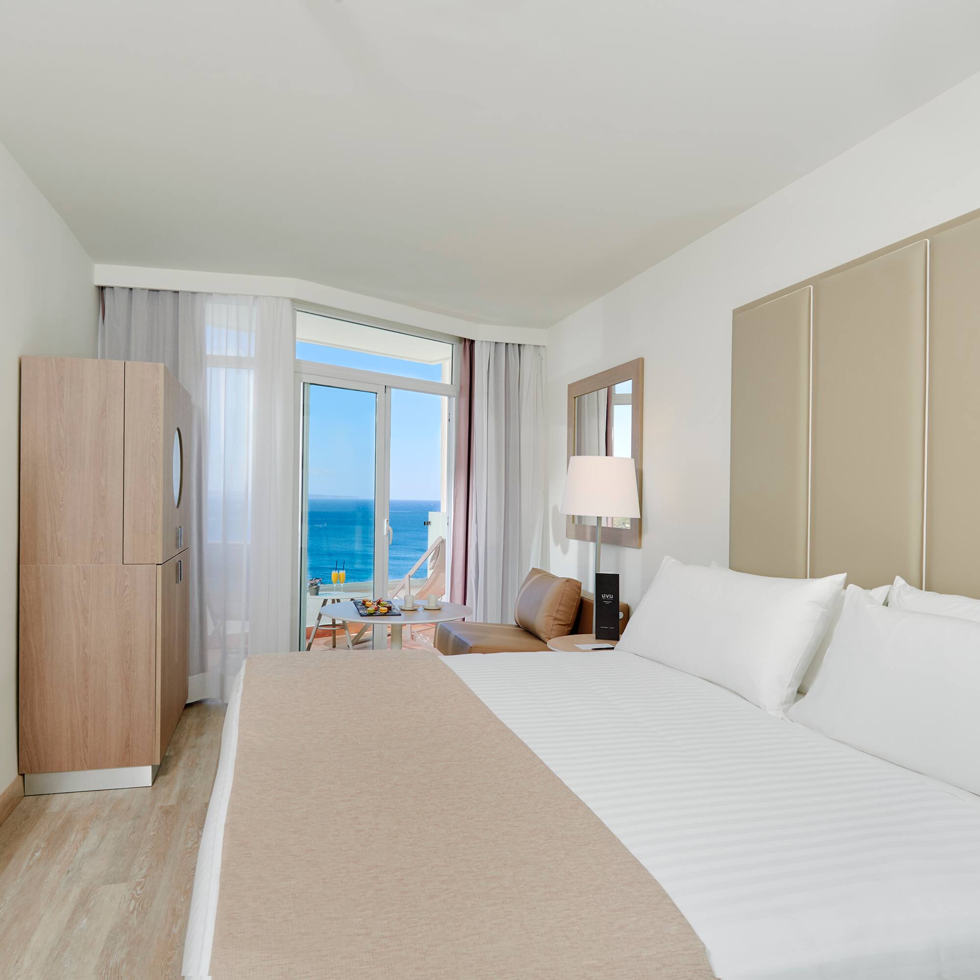 a room with a bed and a table and chairs