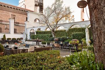 a courtyard with tables and chairs