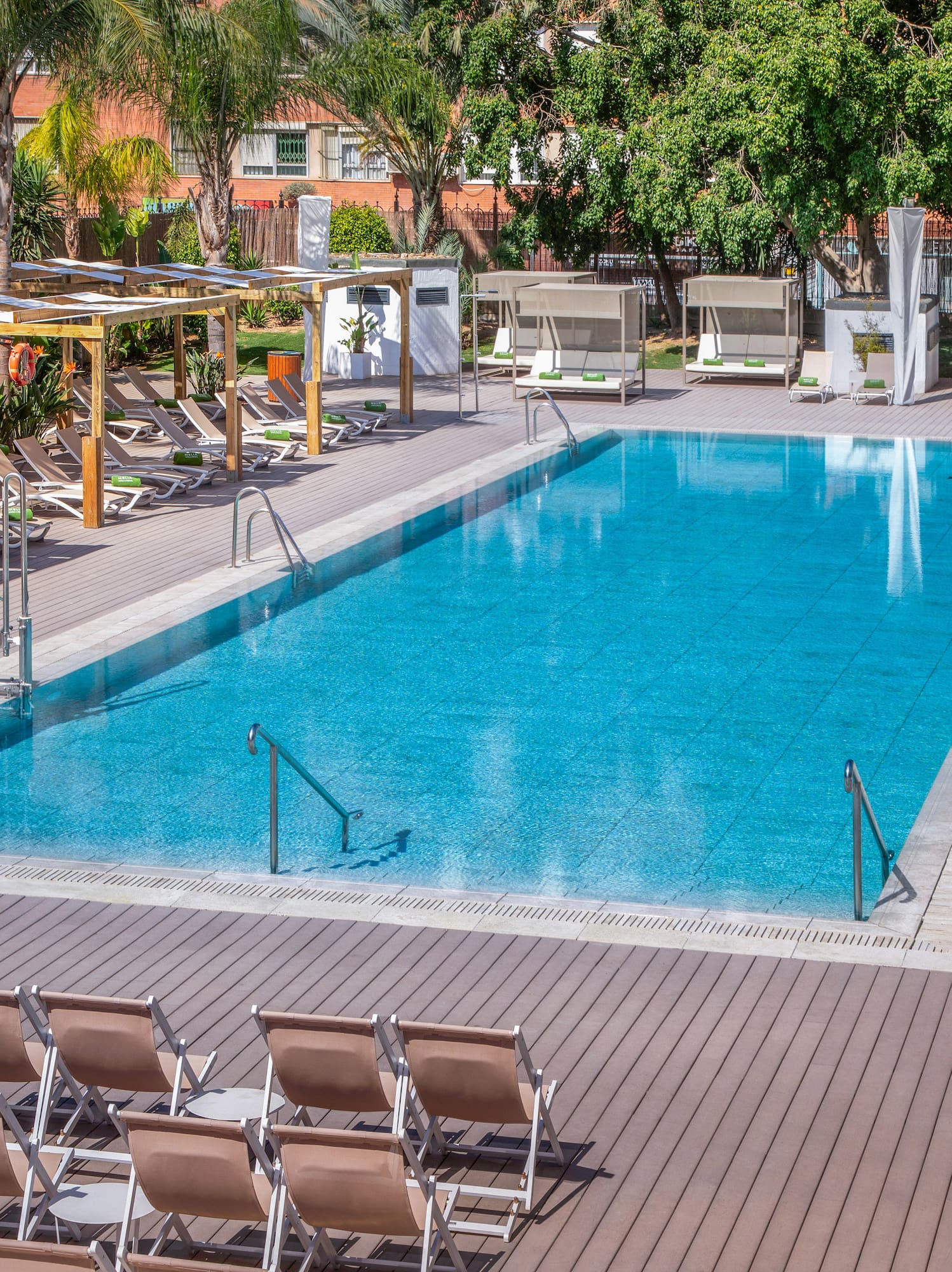 a pool with chairs and a deck