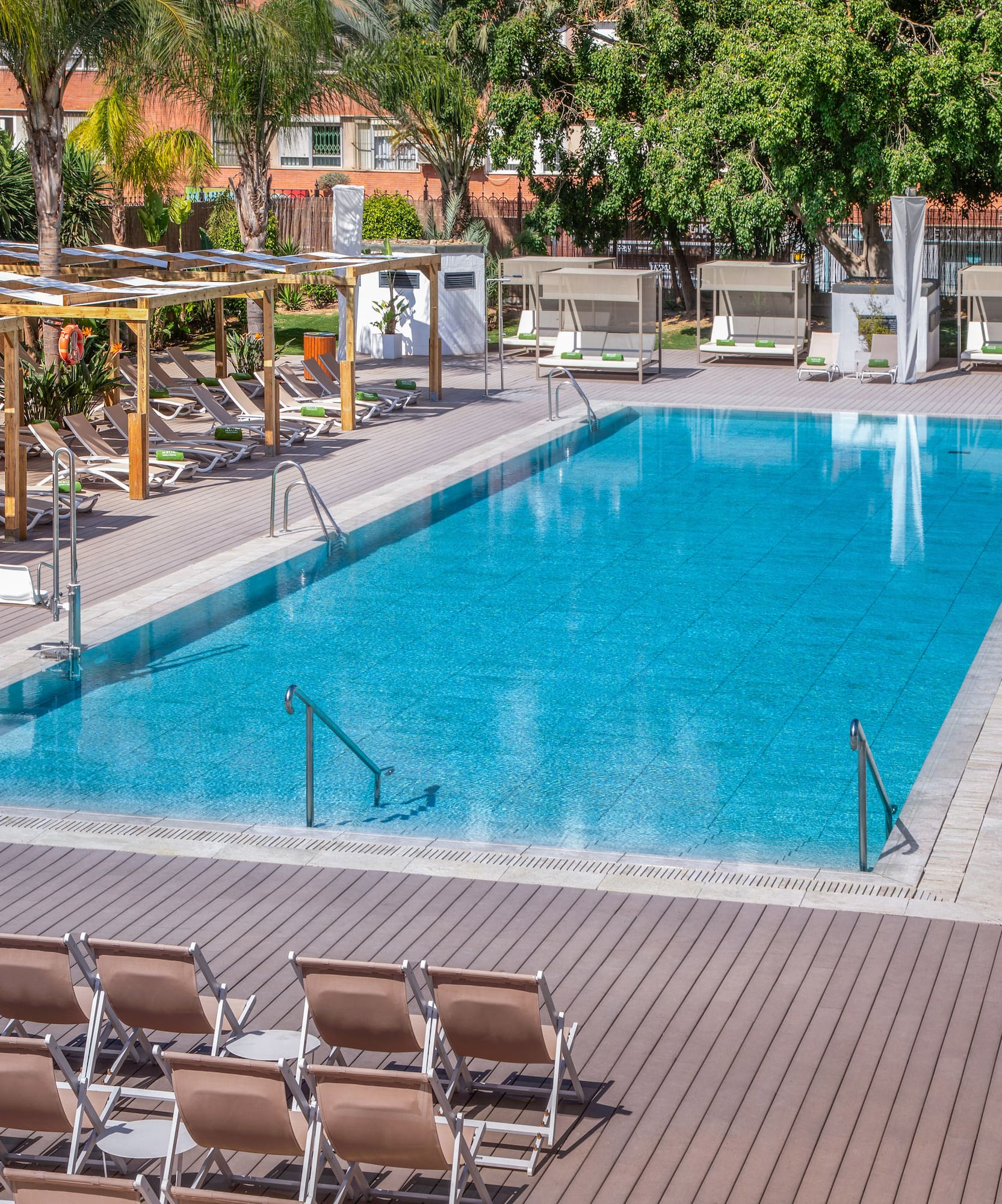 a pool with chairs and a deck