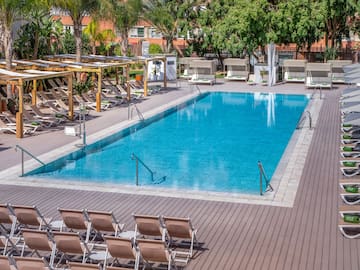 a pool with chairs and a deck