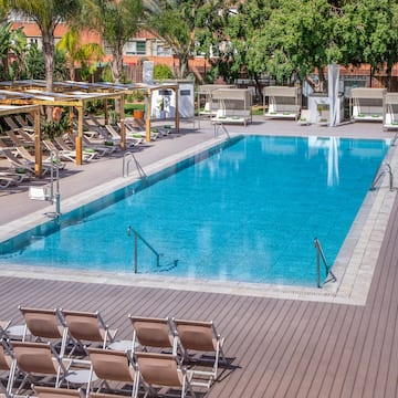 a pool with chairs and a deck