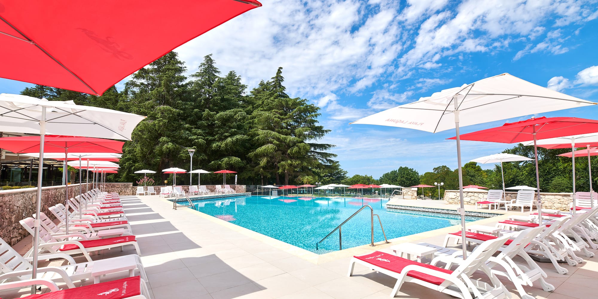 a pool with umbrellas and chairs