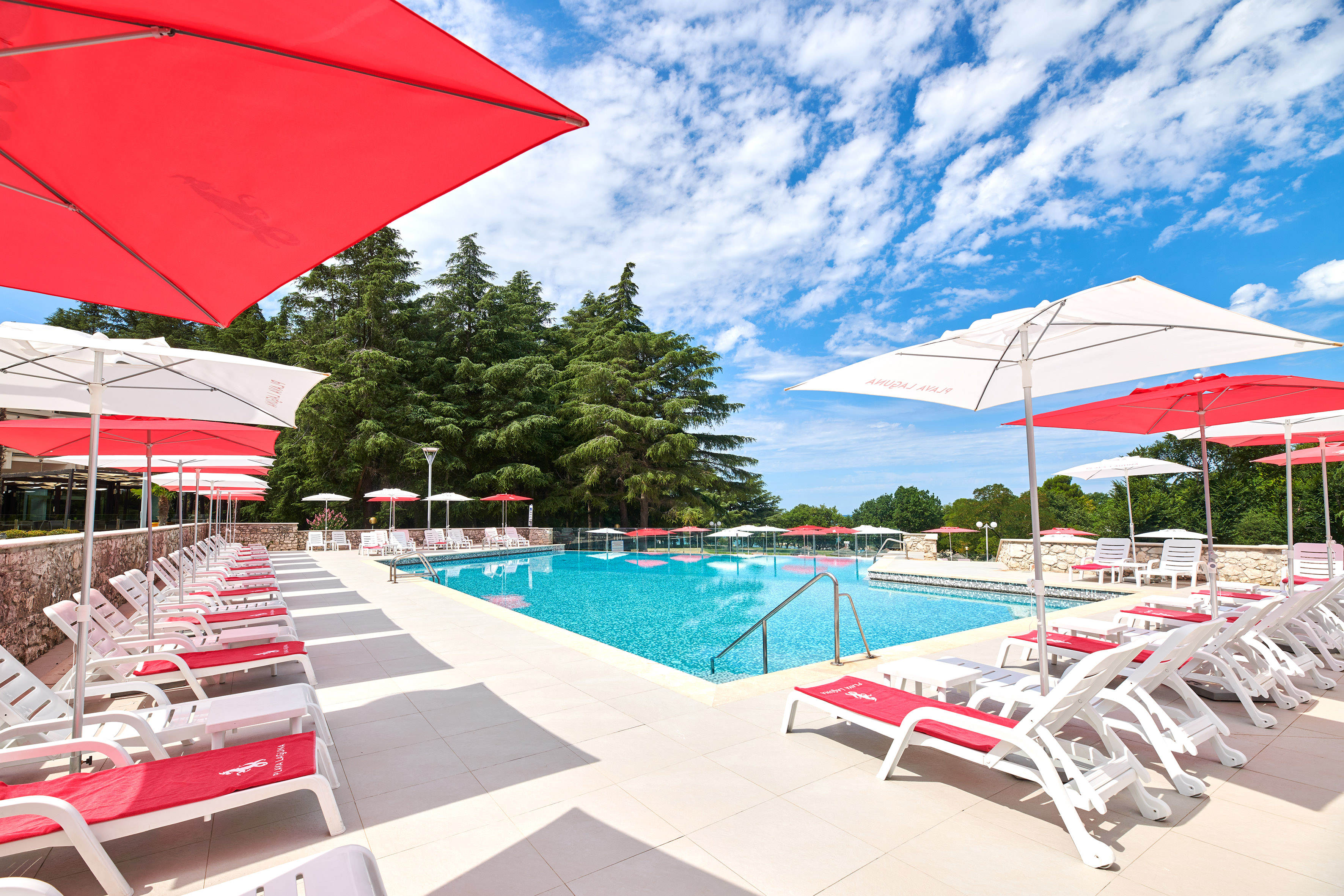 a pool with umbrellas and chairs