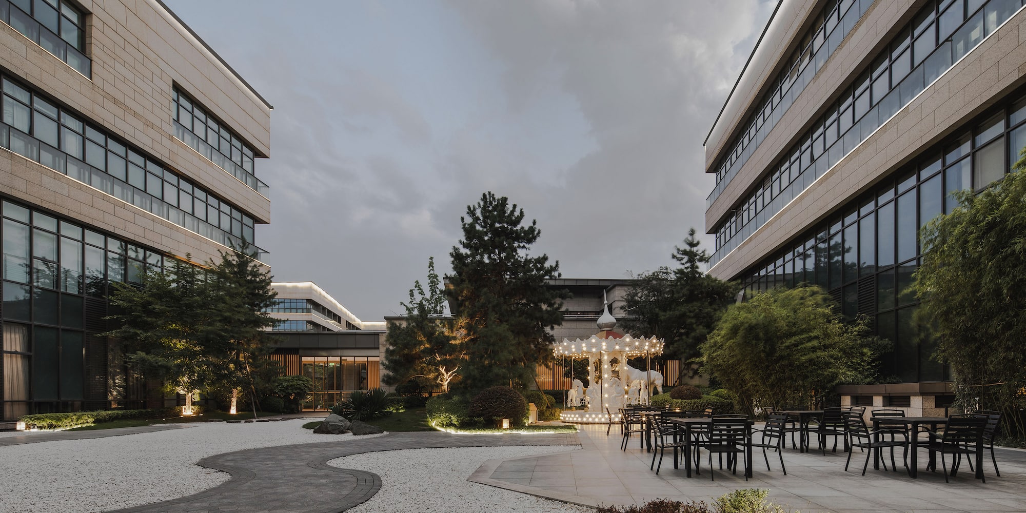 a building with a courtyard and chairs