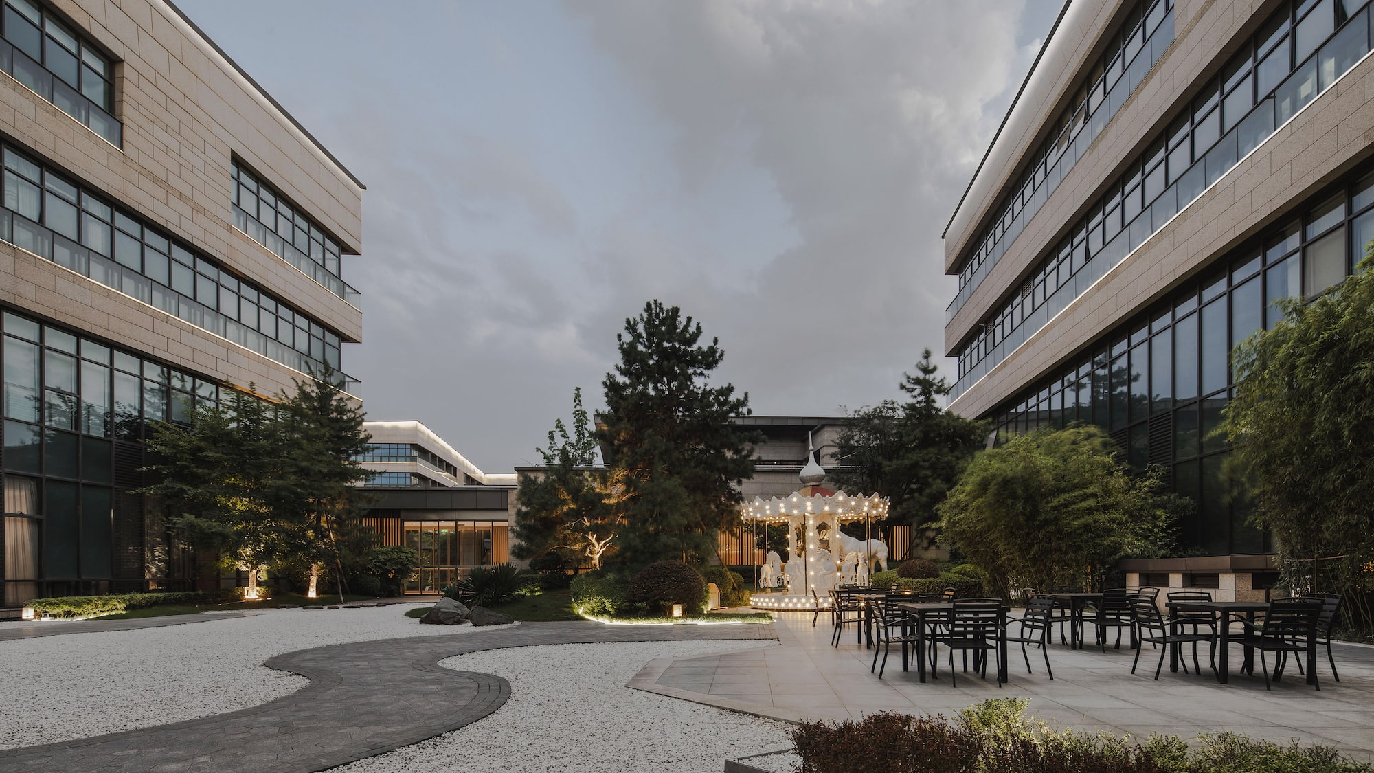 a building with a courtyard and chairs