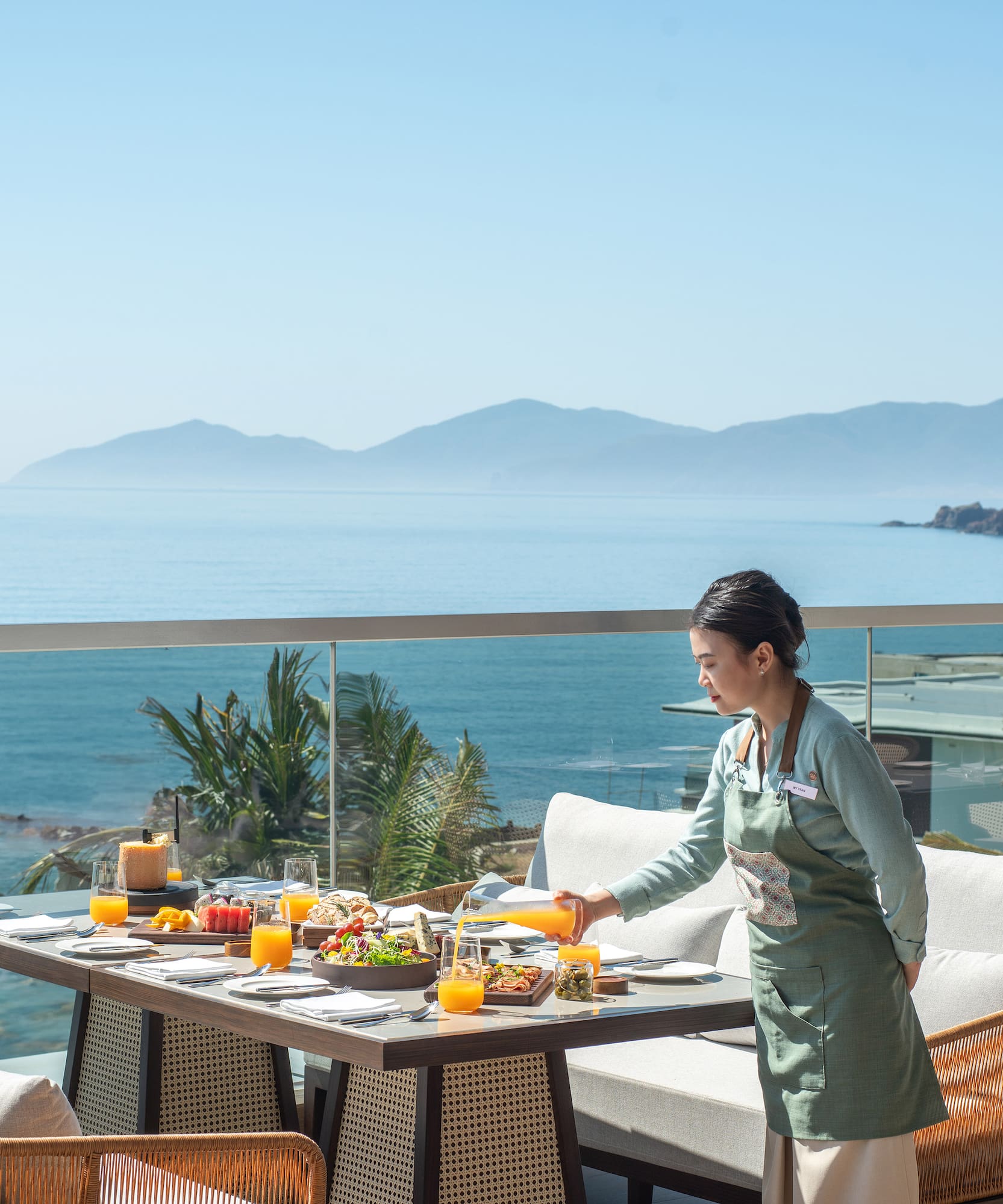 a woman serving food on a table outside