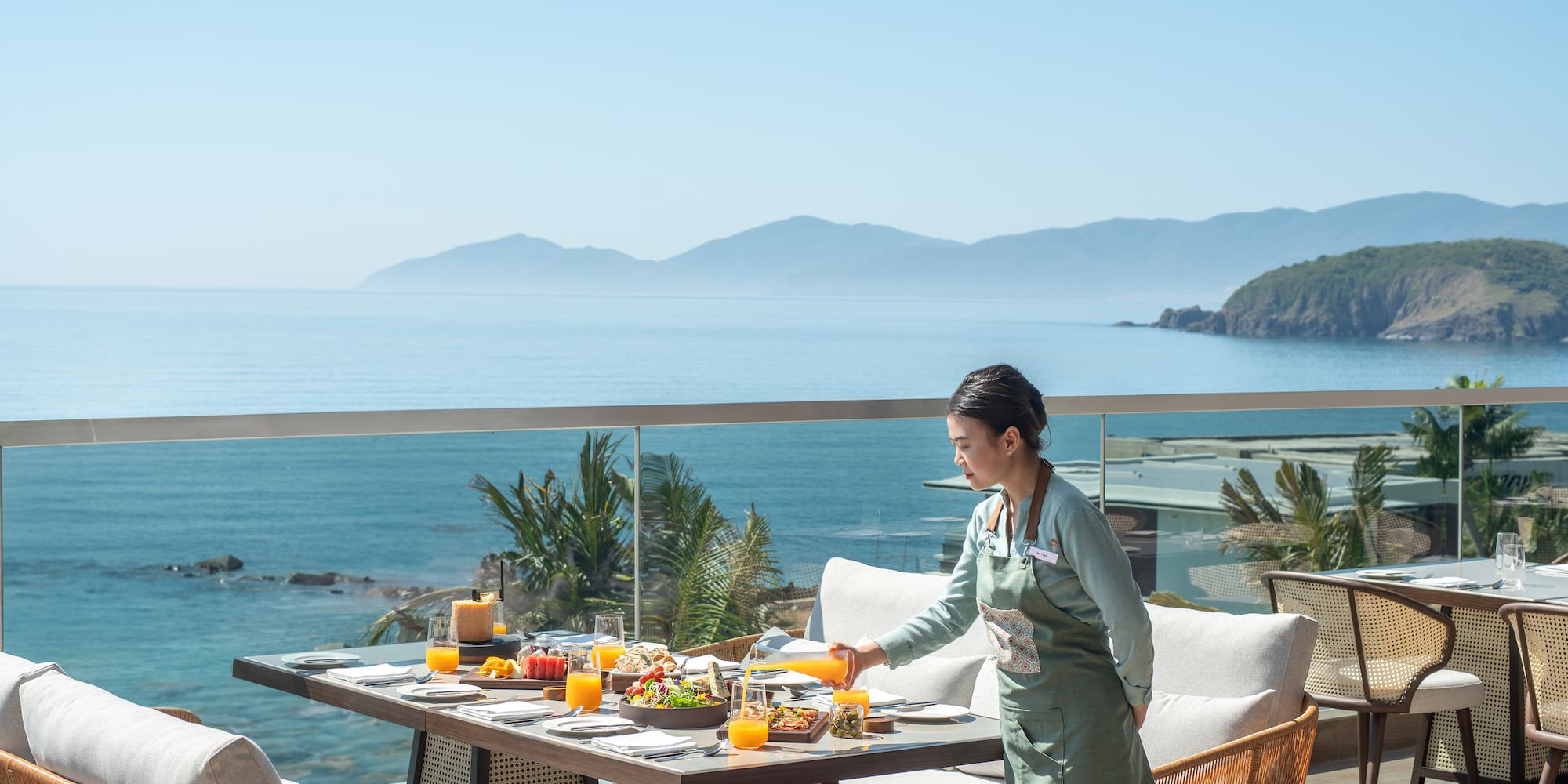 a woman serving food on a table outside