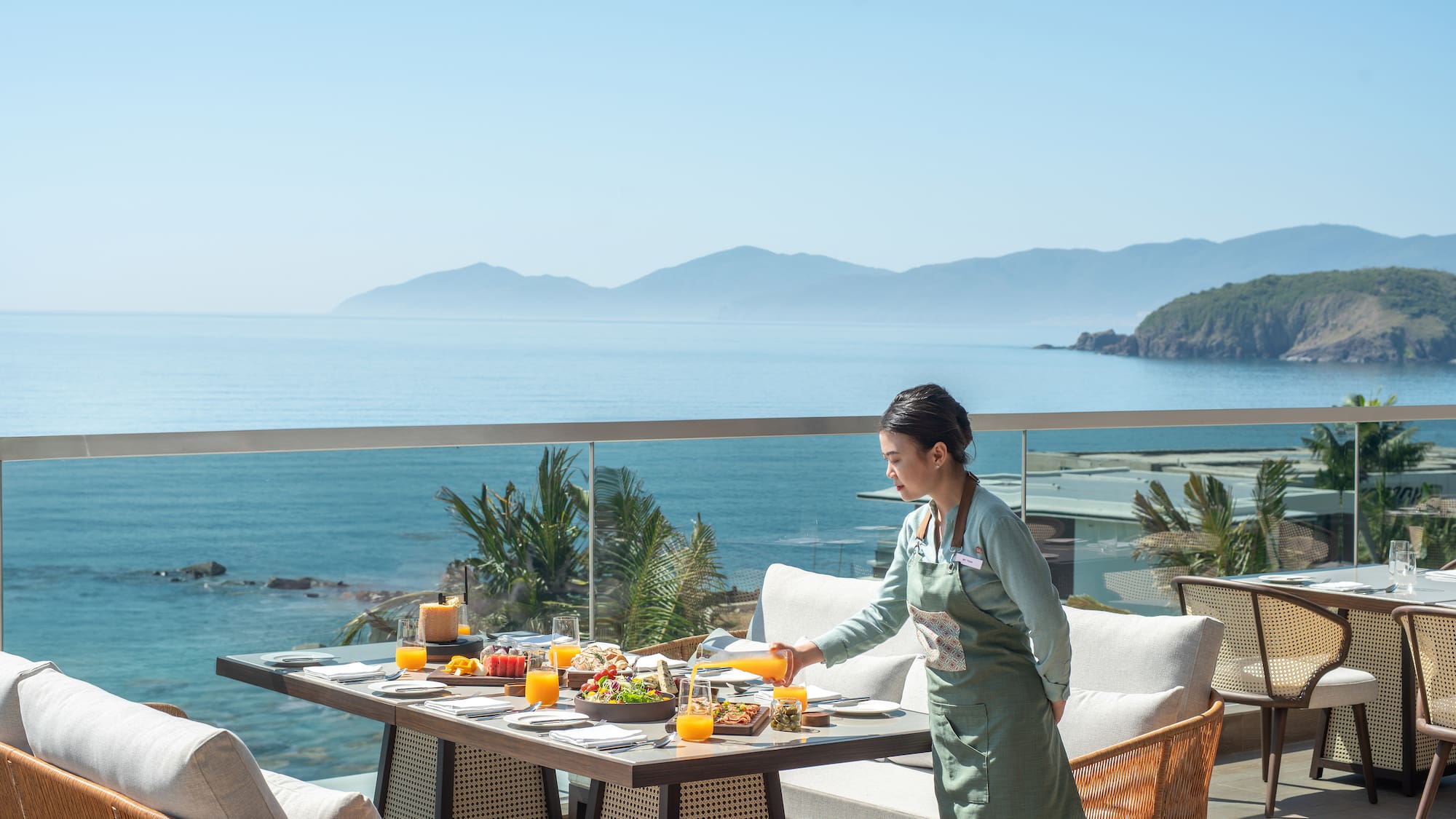 a woman serving food on a table outside