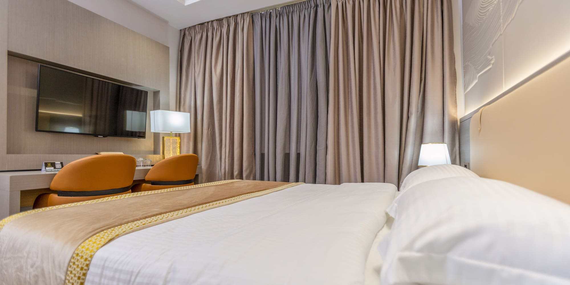 a bed with a lamp and a mirror in a room