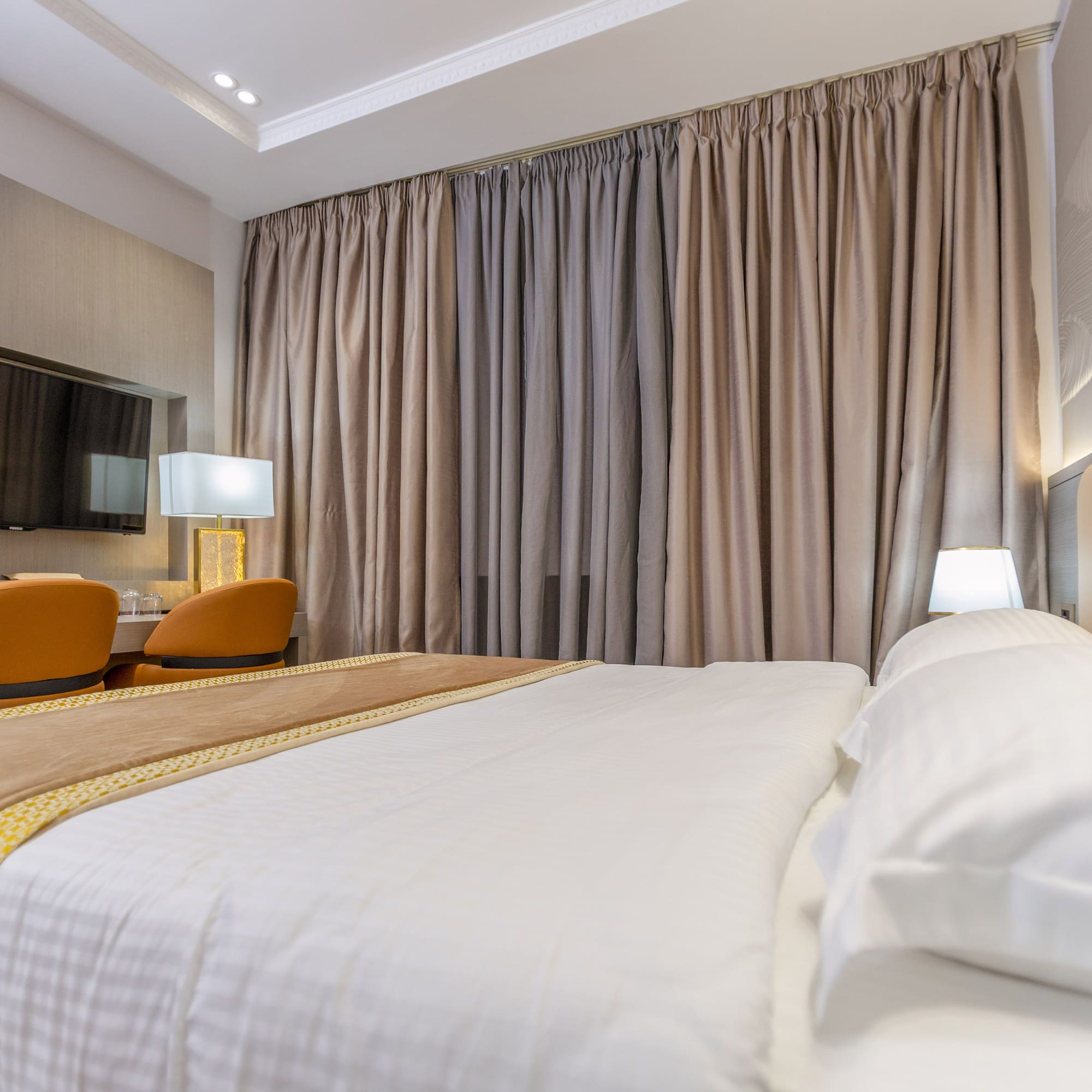 a bed with a lamp and a mirror in a room