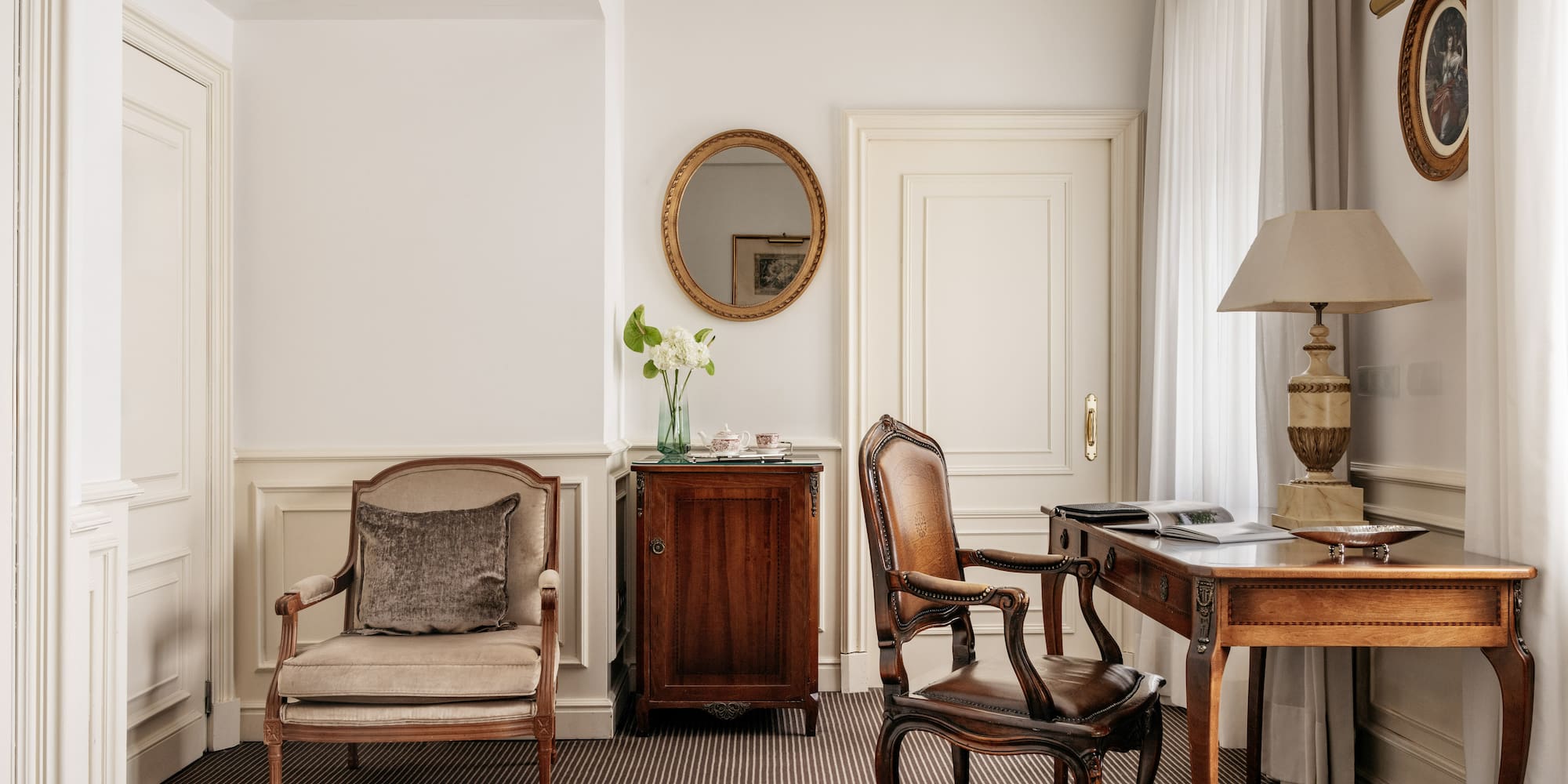 a room with a desk and chairs