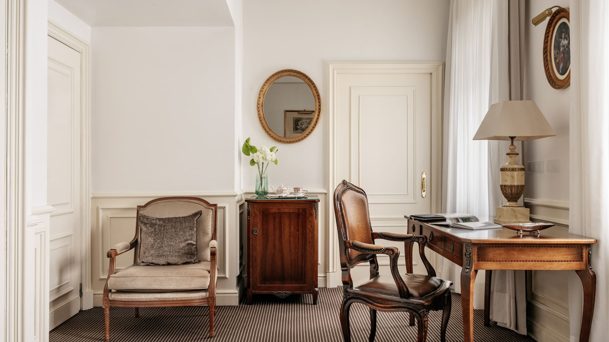 a room with a desk and chairs