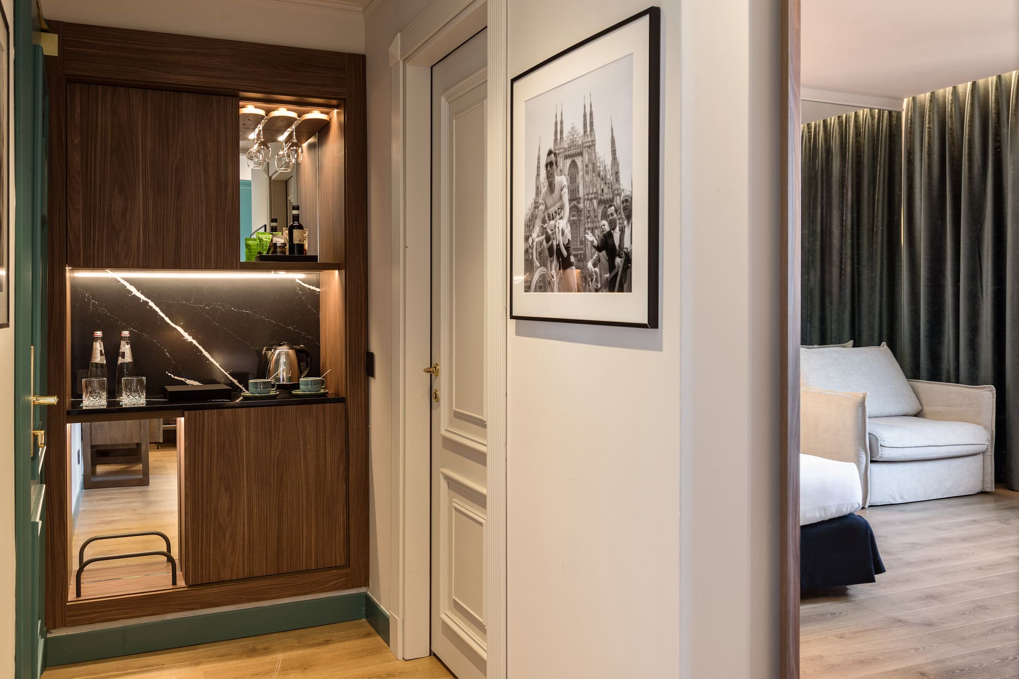 a room with a mirror and a picture on the wall