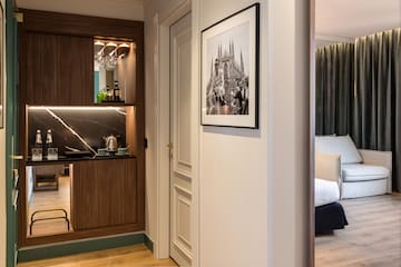 a room with a mirror and a picture on the wall